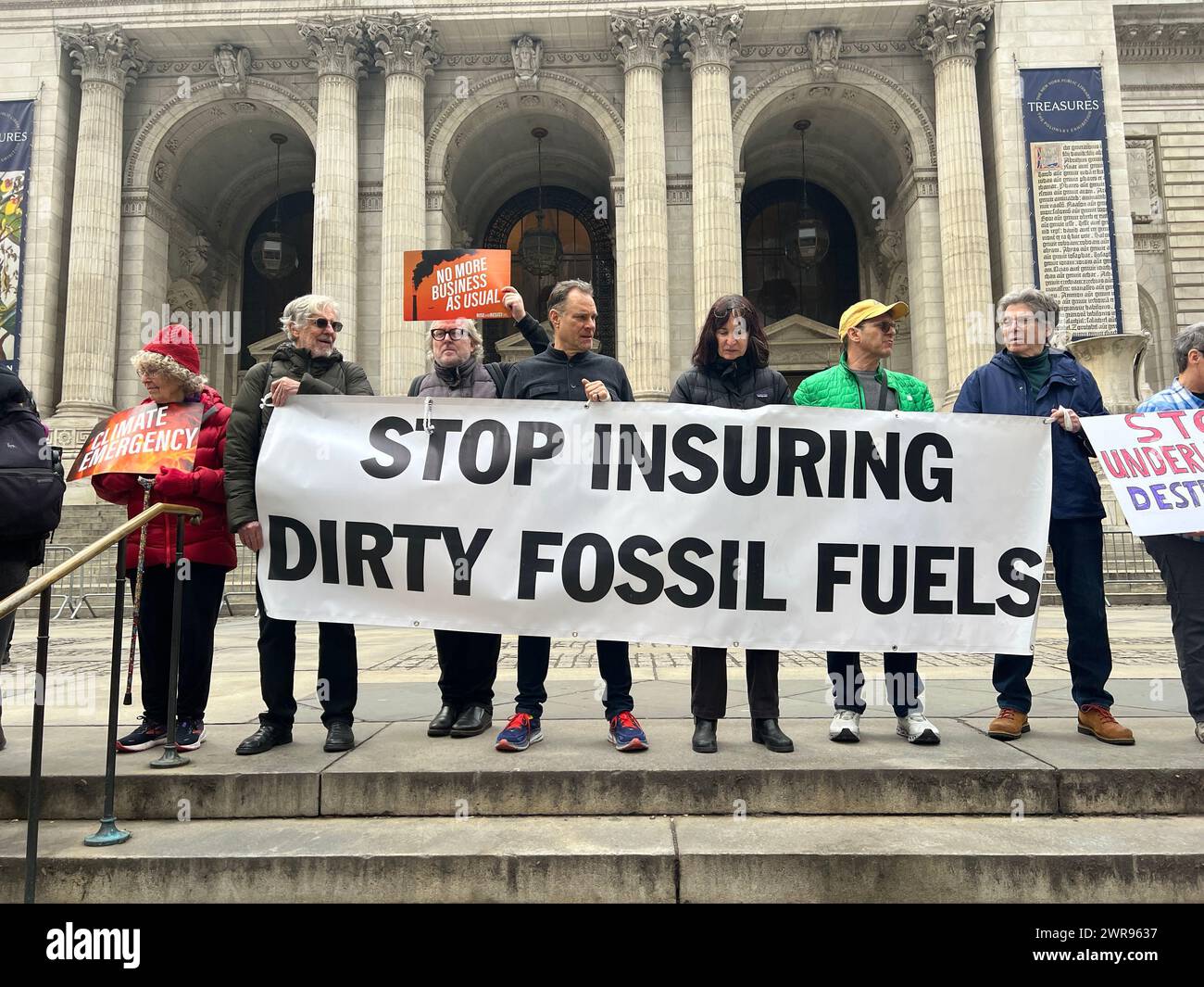 Environmental activists rally and march in New York City telling large insurance companies to stop insuring and supporting the big Fossil Fuel companies. Stock Photo