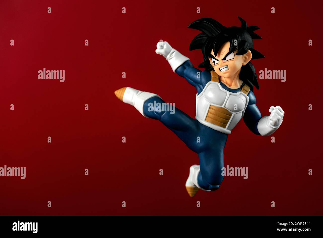 Figure of Son Gohan character of the Dragon Ball Z manga series created by Akira Toriyama over red background. Illustrative editorial Stock Photo