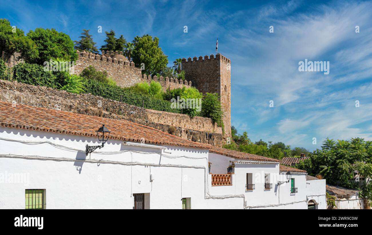 A quaint town with a historic castle crowning its skyline Stock Photo