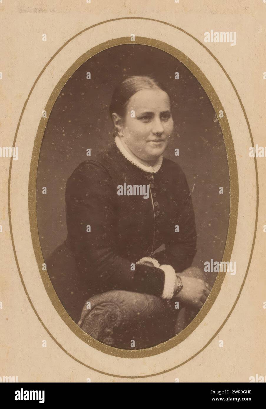 Portrait of a woman leaning on an armchair, This photo is part of an album., C. van der Aa & J. Chrispijn, Camillus Franciscus van der Aa, Jacques Chrispijn, Noord-Holland, 1884 - 1895, photographic support, albumen print, height 82 mm × width 51 mm, photograph Stock Photo