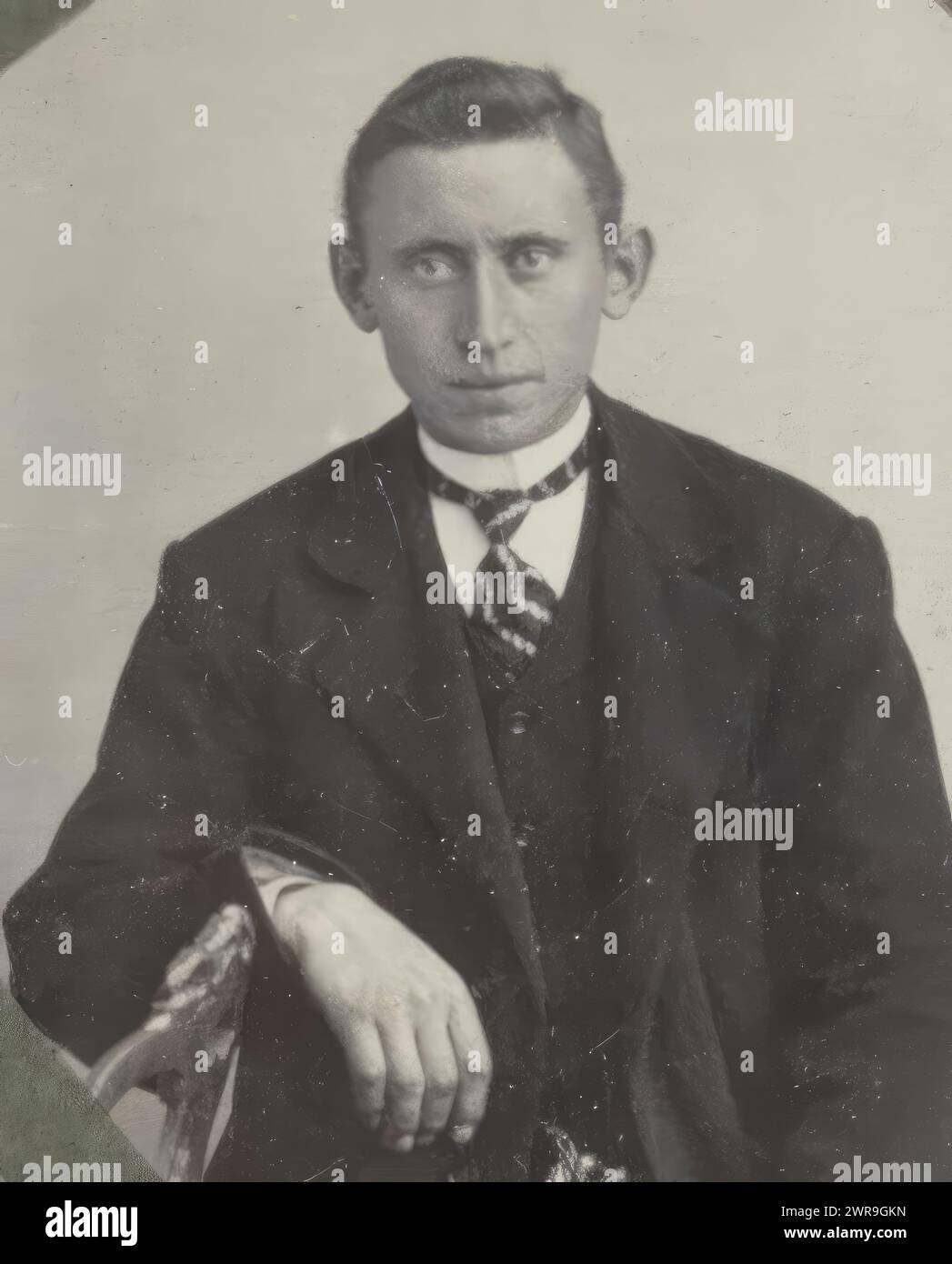 Portrait of a seated man with a striped tie, referred to as 'Father', Part of Album with vending machine photos of a Dutch family., anonymous, Netherlands, c. 1910 - c. 1920, cardboard, height 41 mm × width 29 mm, photograph Stock Photo
