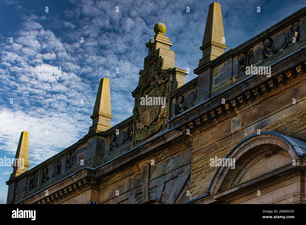 Historic building facade with ornate sculptures against a blue sky with ...