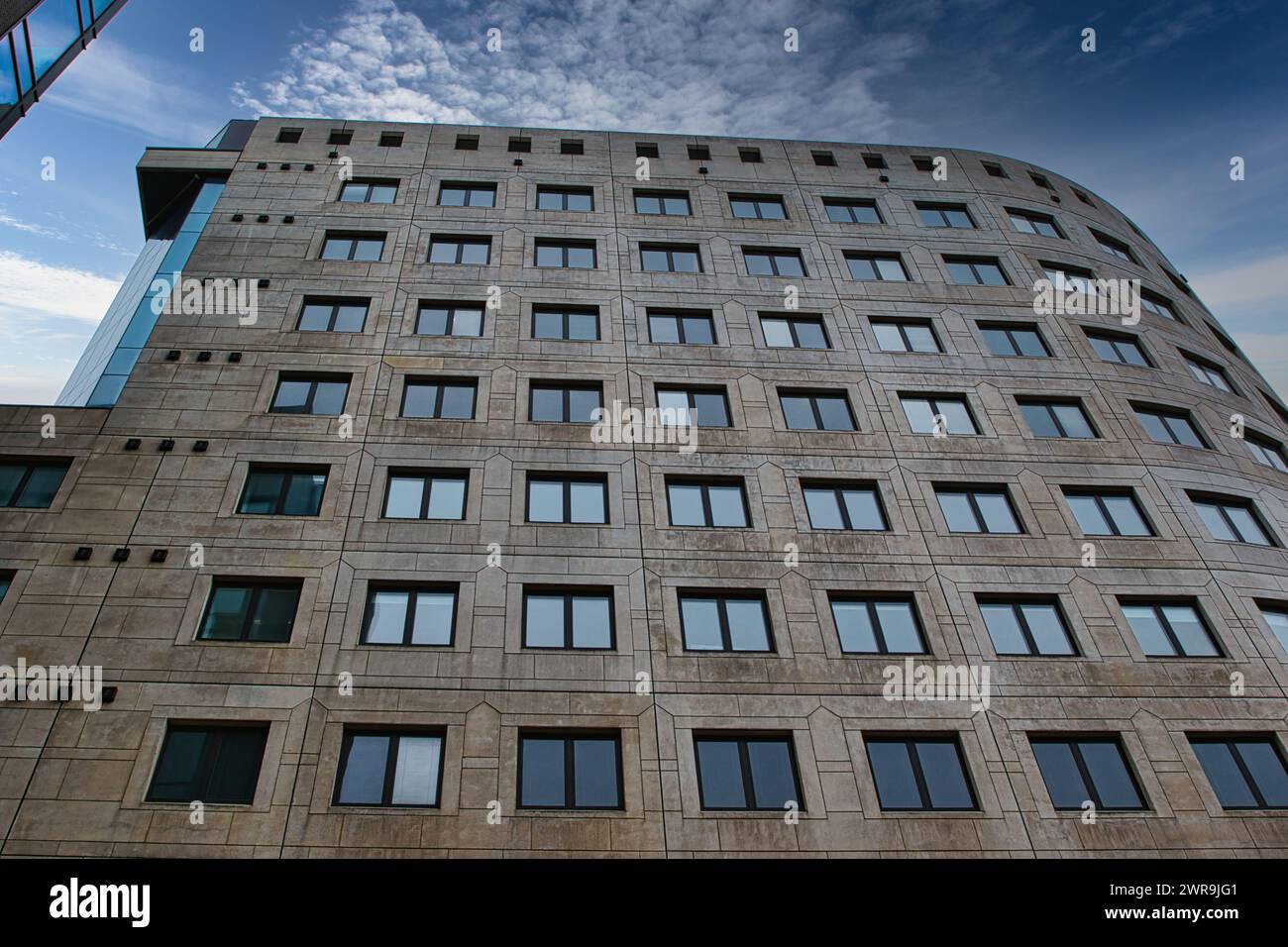 Modern office building facade with geometric windows against a clear ...