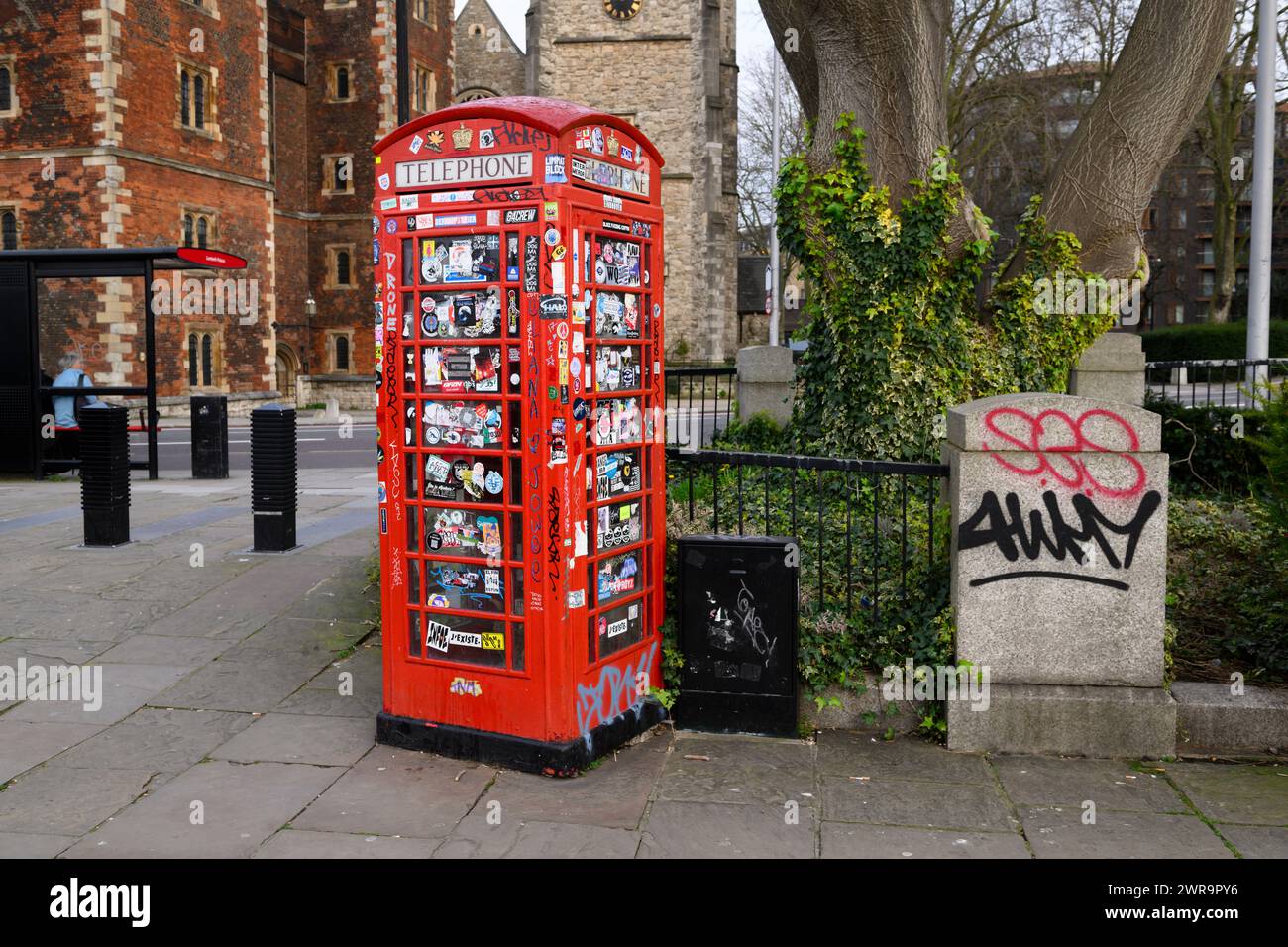 A decommissioned K6 phone box covered in stickers and graffiti, Lambeth Palace Road, London, UK.  9 Mar 2024 Stock Photo