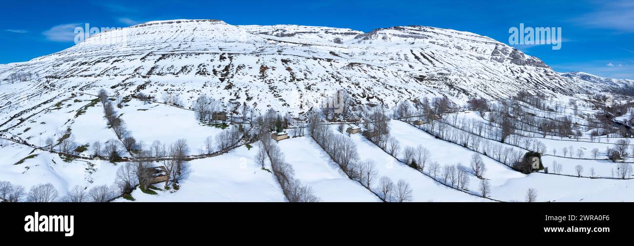 Winter landscape covered in snow in the surroundings of Guarguero waterfalls around the port of Estacas de Trueba. Aerial view from a drone. Espinosa Stock Photo