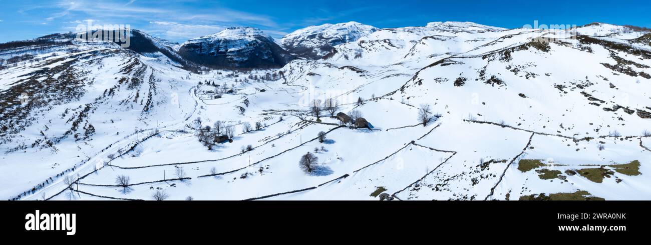Winter landscape covered in snow in the surroundings of Guarguero waterfalls around the port of Estacas de Trueba. Aerial view from a drone. Espinosa Stock Photo