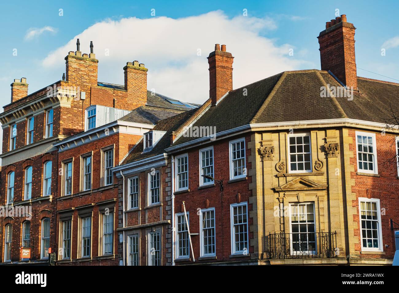 Historic brick buildings with classic British architecture under a ...