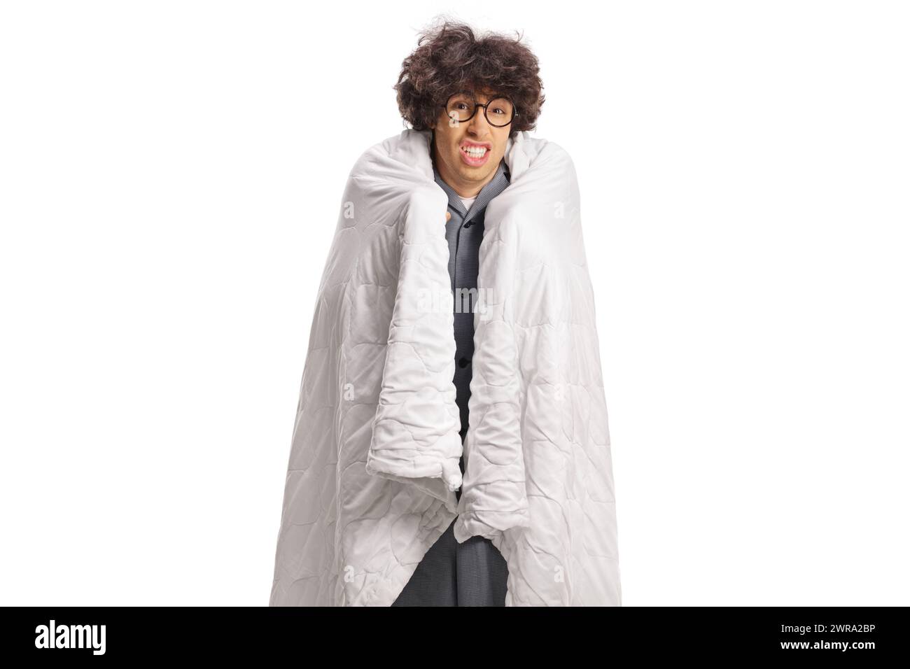 Guy feeling cold wrapped in a blanket isolated on white background Stock Photo