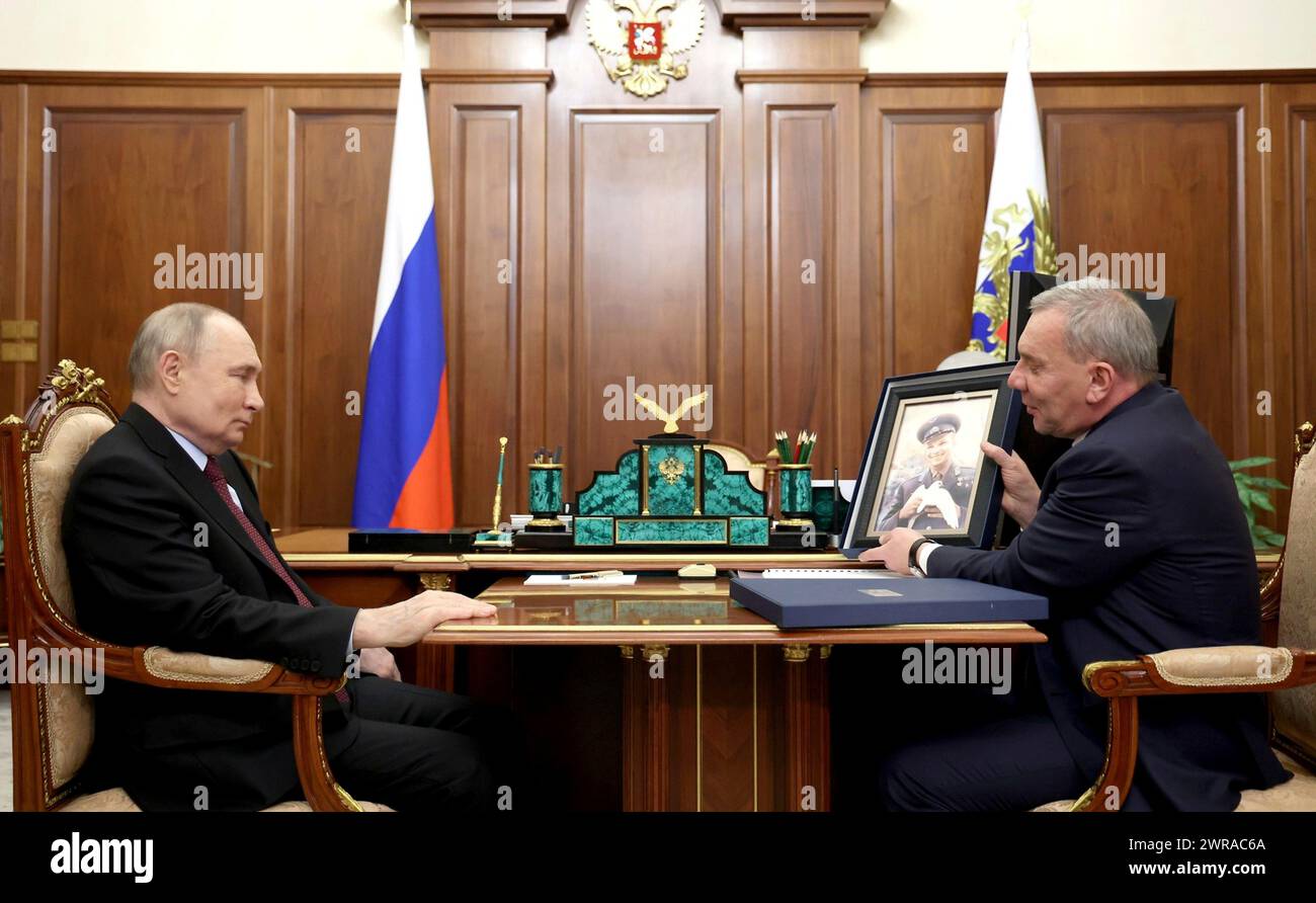 Moscow, Russia. 11th Mar, 2024. Russian state space agency Roscosmos Director General Yury Borisov, right, shows a photo of the first man in space, Yury Gagarin, to Russian President Vladimir Putin, left, during a meeting at the Kremlin, March 11, 2024 in Moscow, Russia. This year marks the 90th birthday anniversary of cosmonaut Yury Gagarin. Credit: Mikhail Metzel/Kremlin Pool/Alamy Live News Stock Photo