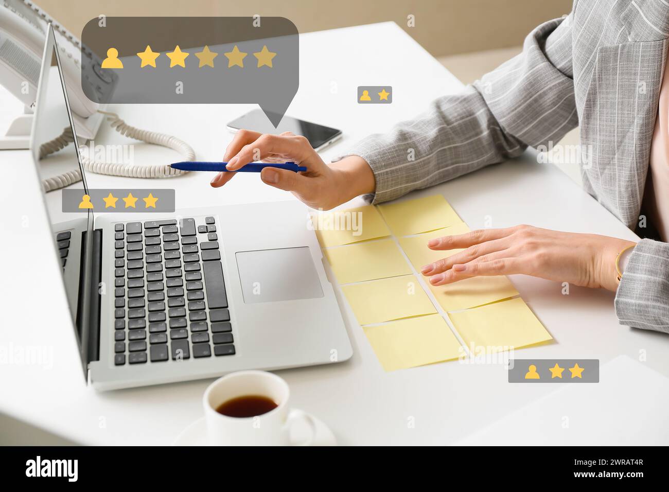 Woman with laptop giving rating to new website in office Stock Photo