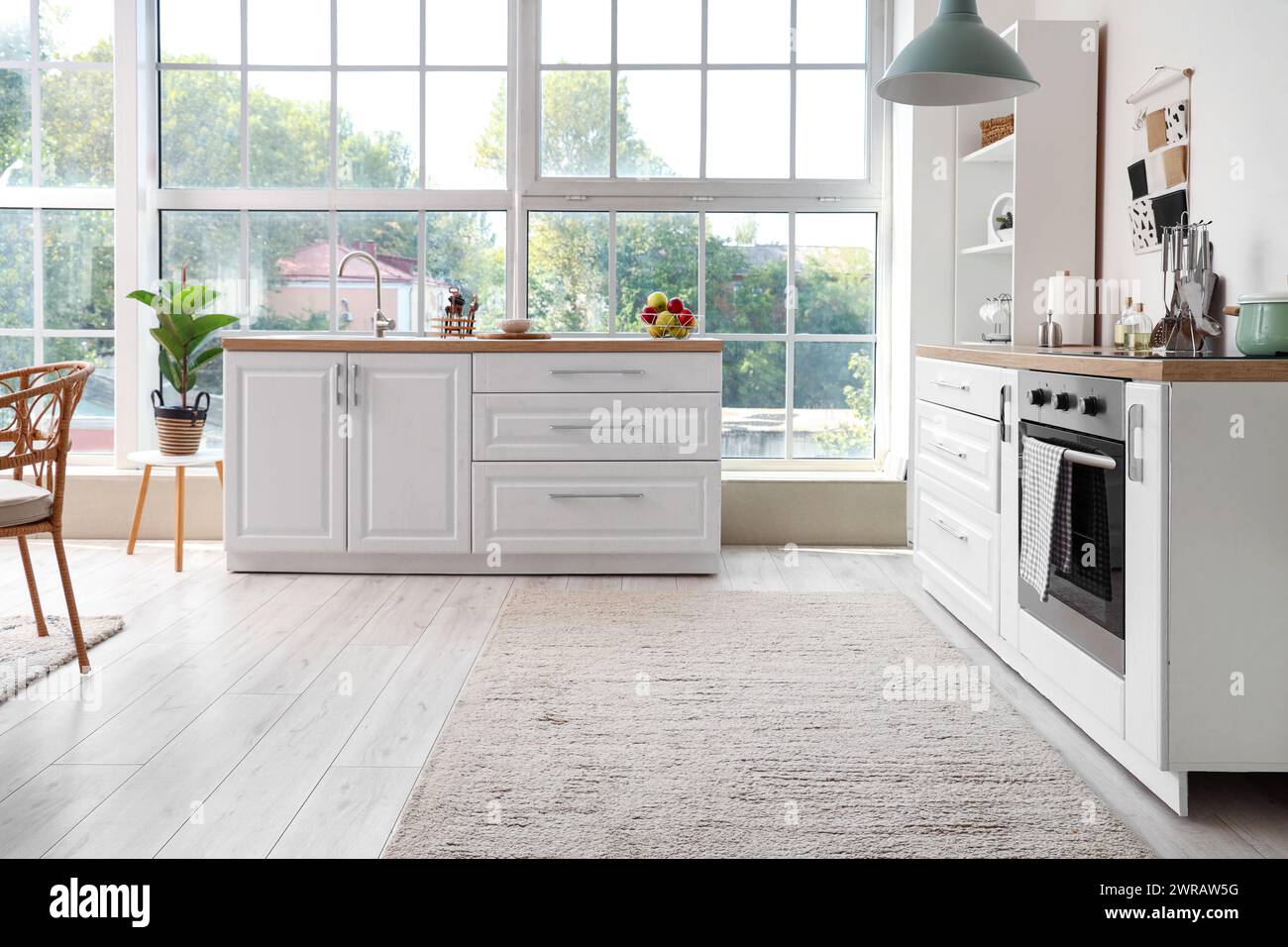 Interior of kitchen with white counters and oven Stock Photo - Alamy
