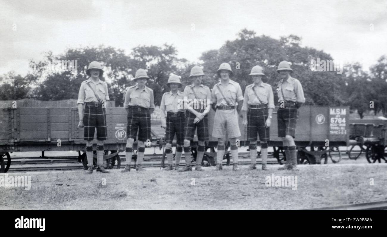Officers of the 2nd Battalion Highland Light Infantry in front of Madras and Southern Mahratta Railway trucks in British India, c. 1925. Stock Photo