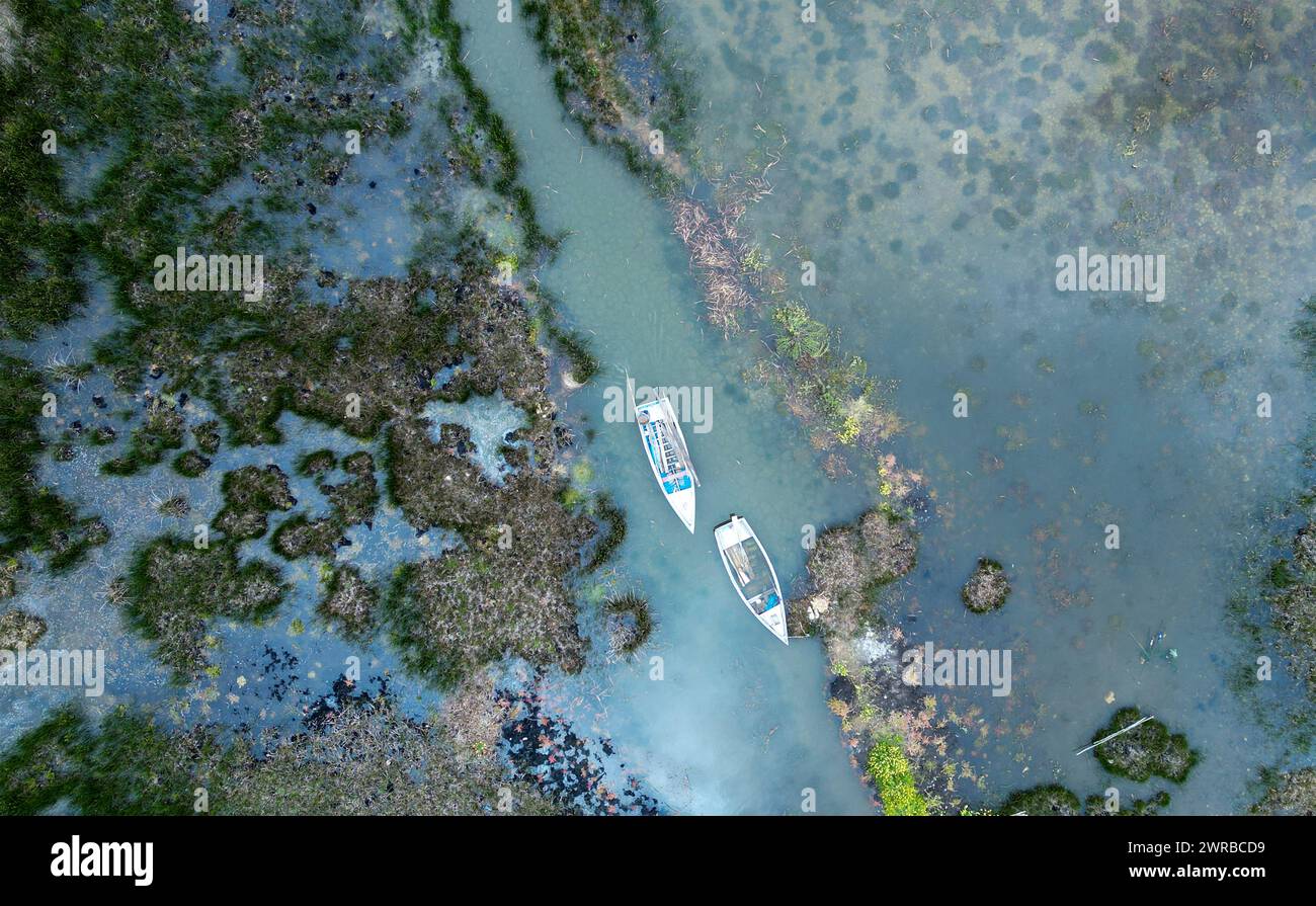 Boats float along the flooded shores of Lake Titicaca in Isla de Cojata