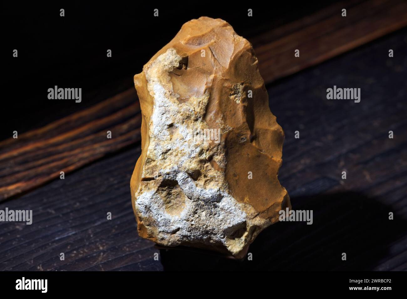 Stone ax made of brown flint with remains of a nodule crust, a Stone Age tool Stock Photo