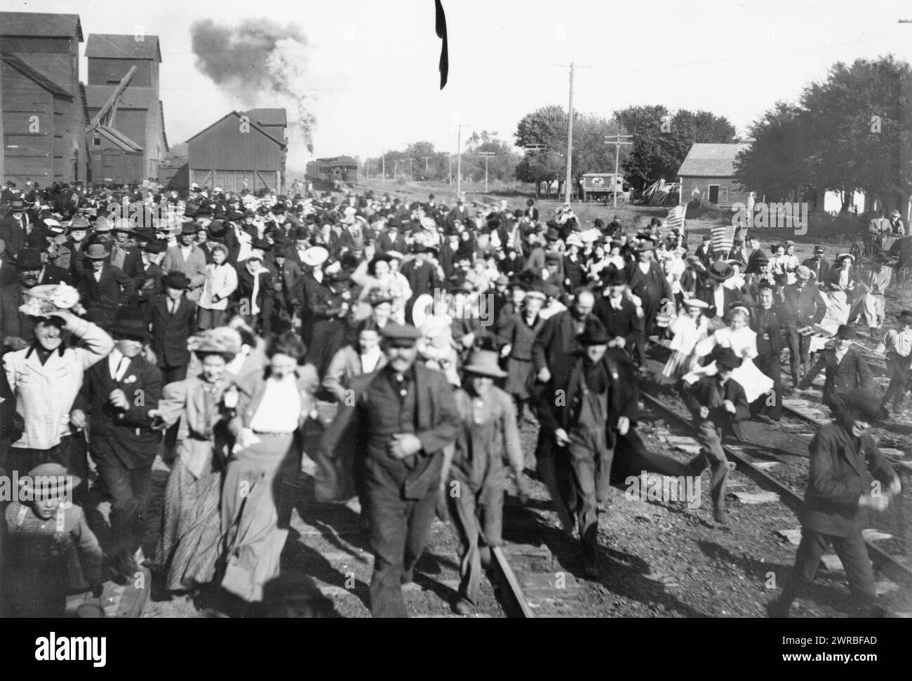 Crowd to greet Wm. H. Taft, De Witt, Nebraska, 1908, Crowd running along railroad tracks to greet Taft during his campaign tour., 1908, printed between 1960 and 1980, Taft, William H., (William Howard), 1857-1930, Journeys, Nebraska, De Witt, Photographic prints, 1960-1980., Photographic prints, 1960-1980, 1 photographic print Stock Photo