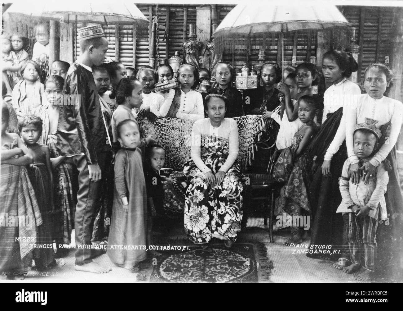 Princes sic Radcai.e. Radja? Putrie and attendants, Cottabatoi.e. Cotabato, P.I., Piang Studio, Zamboanga, P.I., Princess Radja(?) Putri, wife of the Sultan Maguguina, and attendants, Cotabato, Philippine Islands., between ca. 1900 and 1923, Princesses, Philippines, Cotabato, 1900-1930, Group portraits, 1900-1930., Portrait photographs, 1900-1930, Group portraits, 1900-1930, 1 photographic print Stock Photo
