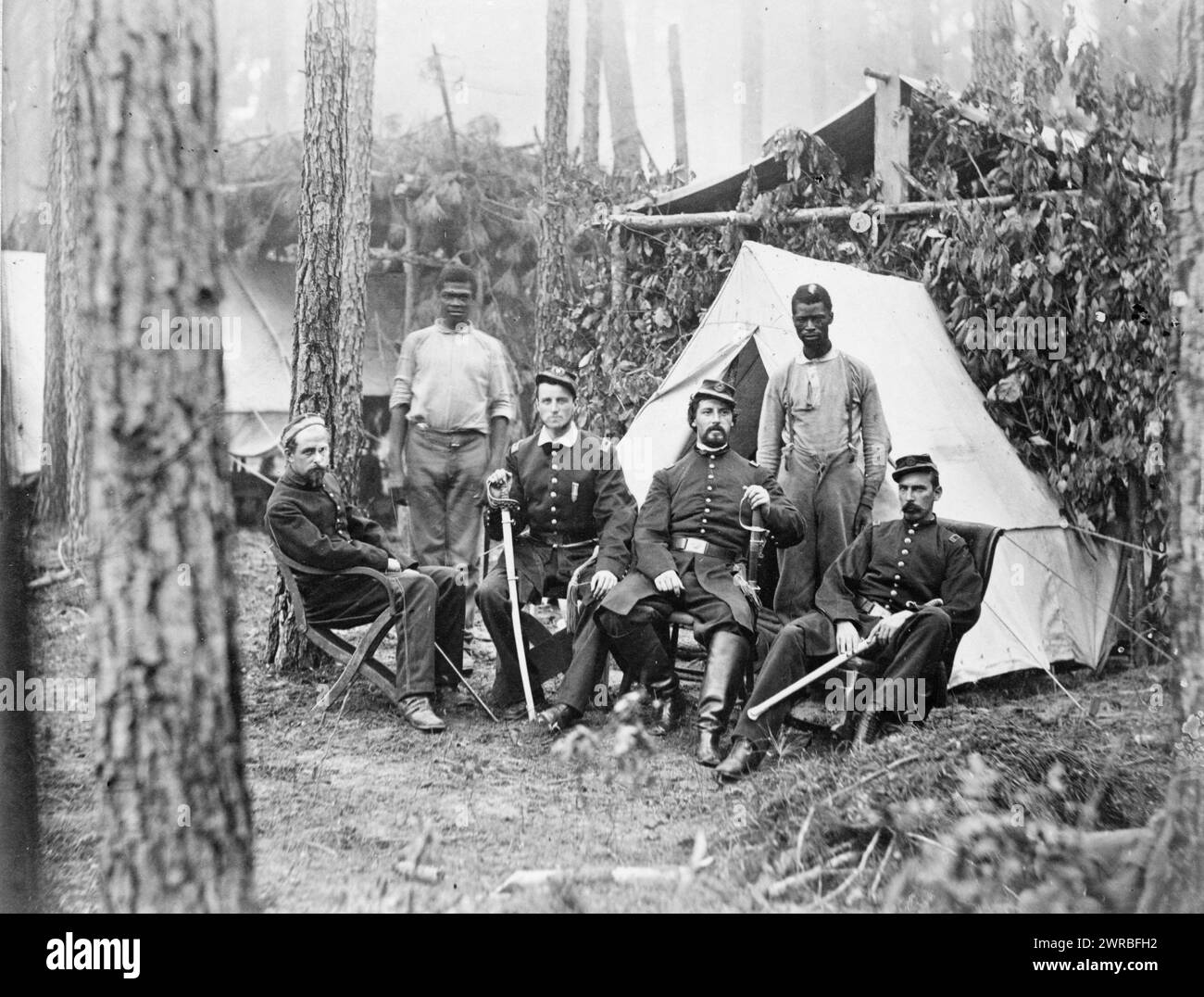 Officers of 114th Pennsylvania Infantry in front of Petersburg, Va., August, 1864, Four union officers in front of tent, with two Afro-American Servants(?), 1864., United States., Army., Pennsylvania Infantry Regiment, 114th (1862-1865), People, Group portraits, 1860-1870., Group portraits, 1860-1870, Portrait photographs, 1860-1870, 1 photoprint Stock Photo