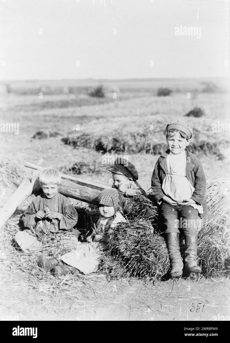 Four children in hay field, Russia, between ca. 1880 and 1924, Children