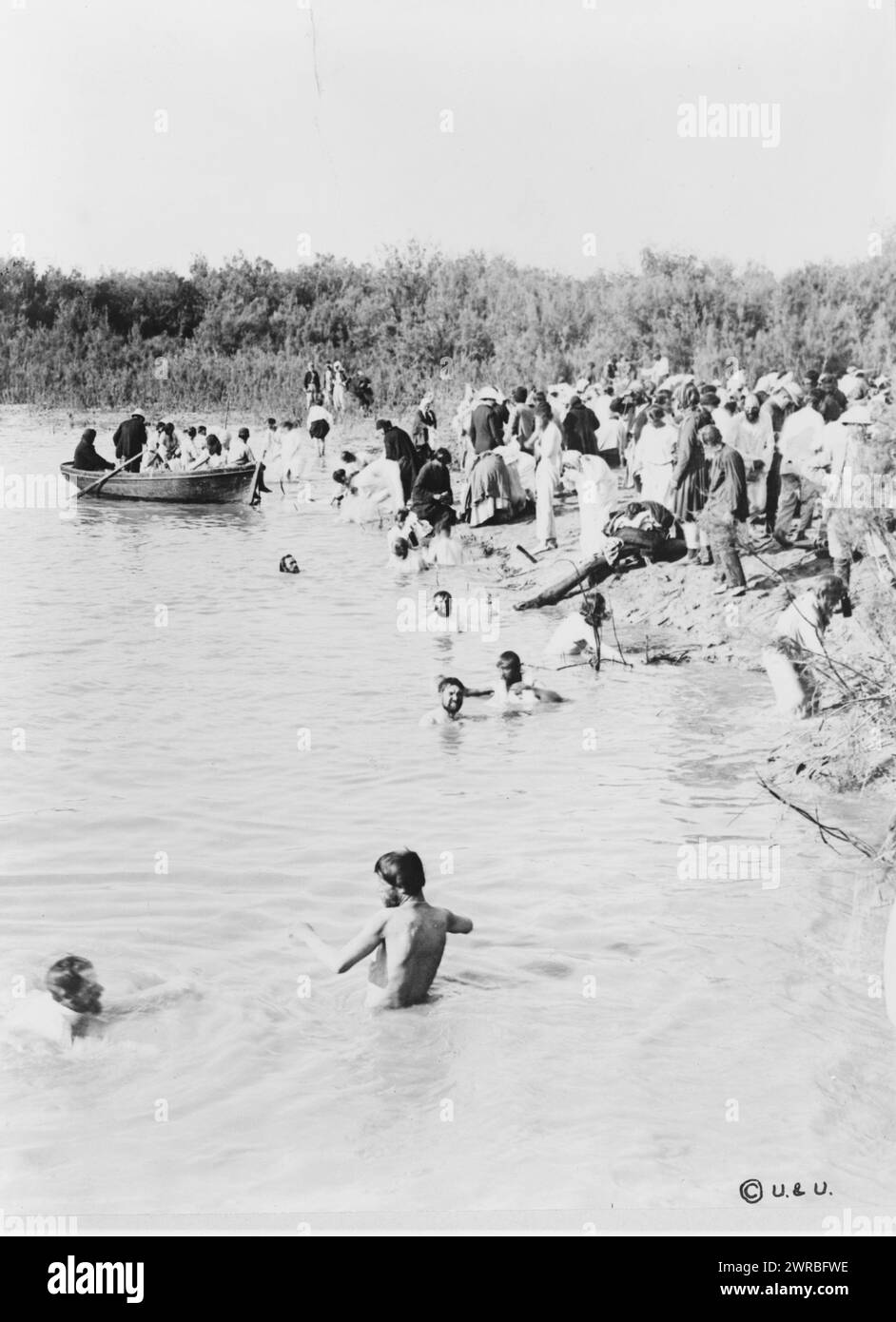 Pilgrims bathing in the Jordan River, after the water has been blessed by priest of the Greek Orthodox Church, between 1880 and 1900, Baptisms, Jordan River, 1880-1900, Photographic prints, 1880-1900., Photographic prints, 1880-1900, 1 photographic print Stock Photo