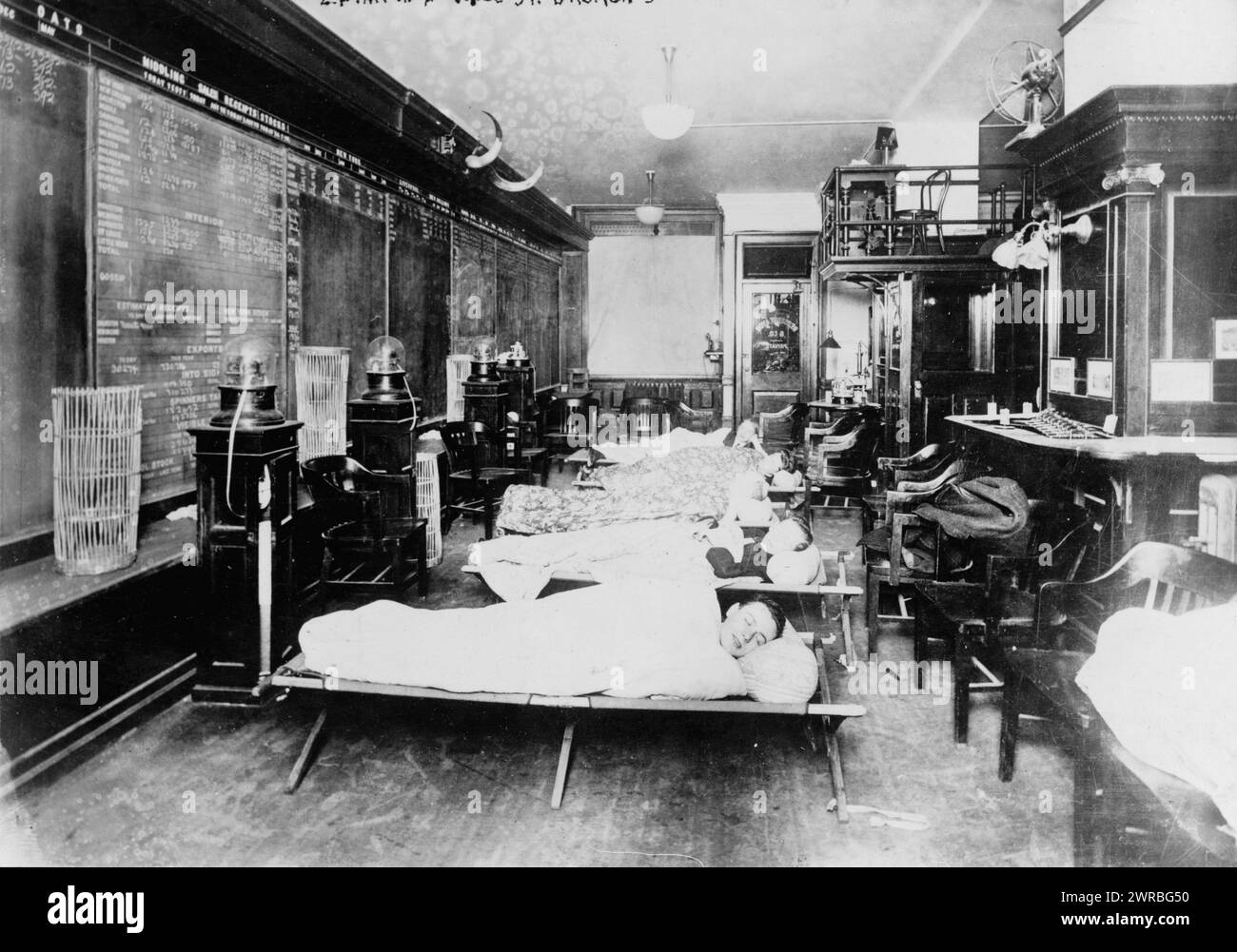 Wall St., N.Y., 2 A.M. in broker's office: Clerks sleeping in office due to excessive work caused by heavy stock business, 1915 Oct. 23, Financial facilities, New York (State), New York, 1920-1930, Photographic prints, 1920-1930., Photographic prints, 1920-1930, 1 photographic print Stock Photo