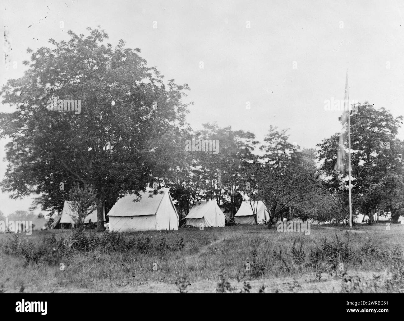 Headquarters of the Army of the Potomac, near Fairfax Court House, Va., June, 1863, Army tents and flagpole in grove of trees., photographed 1863, printed later, Military headquarters, Union, Virginia, Fairfax, 1860-1870, Photographic prints, 1860-1910., Photographic prints, 1860-1910, 1 photographic print Stock Photo