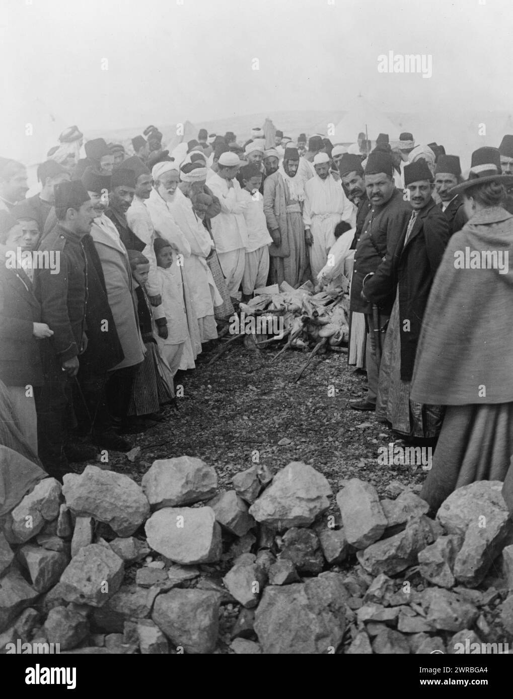 Palestine - Mt. Gerizin ie. Gerizim, Feast of the Passover, Samaritans around meat being cooked over open fire, Mount Gerizim, West Bank., between 1880 and 1922, Samaritans, Spiritual life, West Bank, Gerizim, Mount, Photographic prints, 1880-1920., Photographic prints, 1880-1920, 1 photographic print Stock Photo