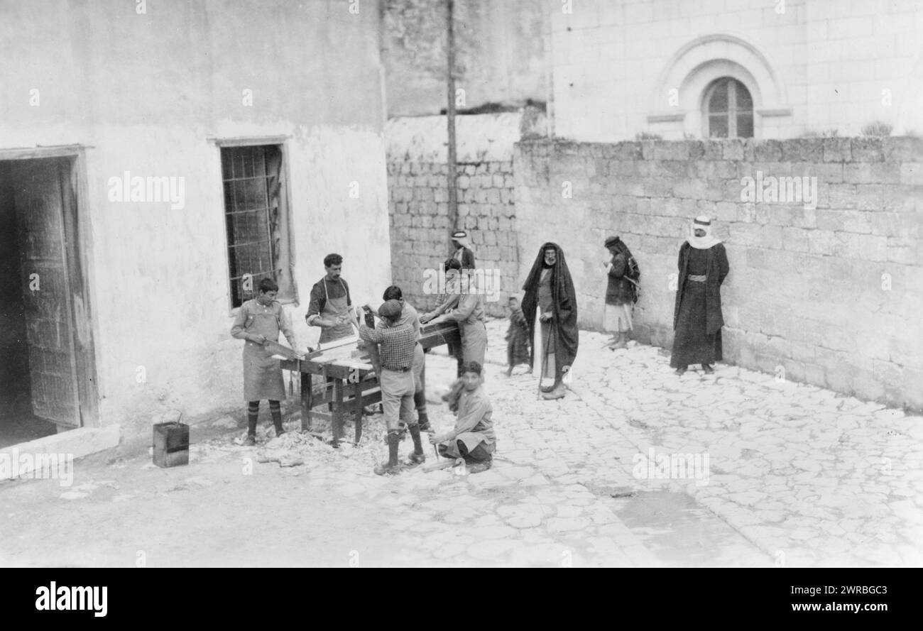 Armenian orphan wards of Near East Relief doing carpentry in courtyard of chapel in Nazareth, Palestine, 1915 or 1916, Near East Relief (Organization), Israel, Nazareth, 1910-1920, Photographic prints, 1910-1920., Photographic prints, 1910-1920, 1 photographic print Stock Photo