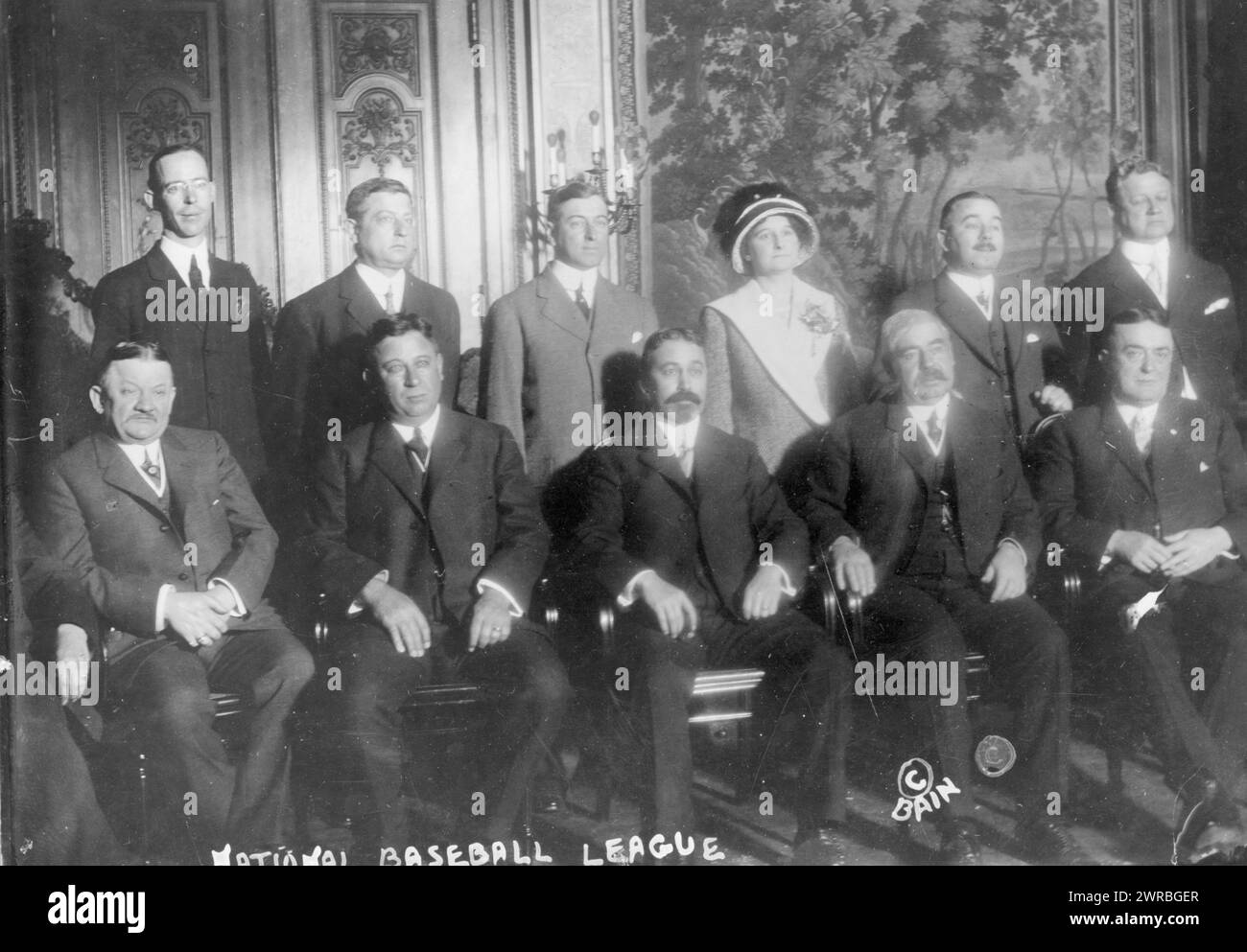 National Baseball League officials, Photograph shows ten men and one woman, seated and standing, posed for portrait in formal setting, and part of another person seated on the far left., 1911 Dec. 13., Major League Baseball (Organization), People, 1910-1920, Group portraits, 1910-1920., Portrait photographs, 1910-1920, Group portraits, 1910-1920, 1 photographic print Stock Photo