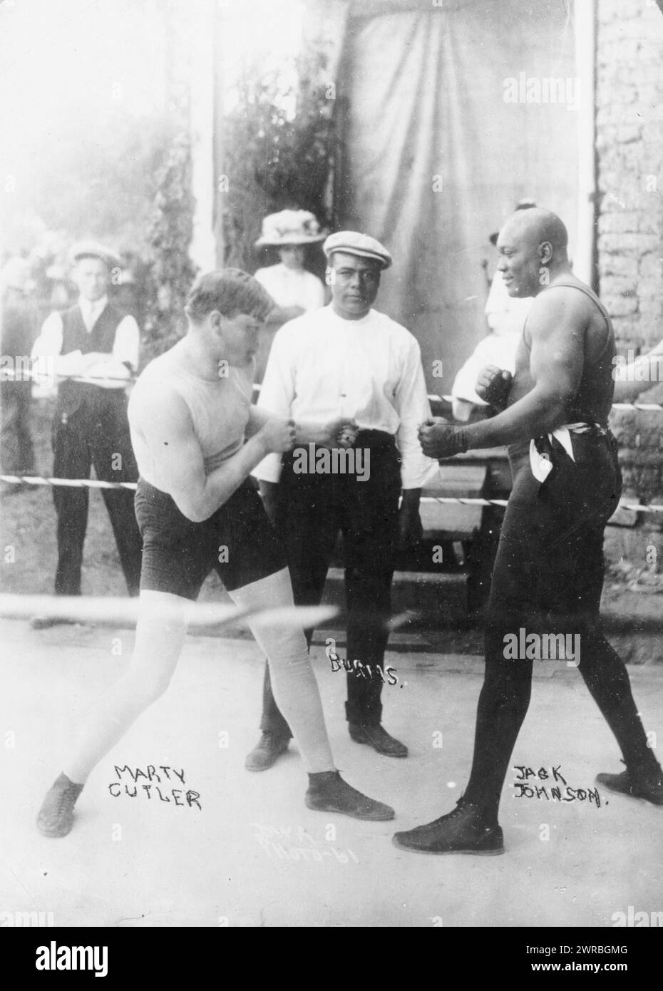 Boxers Marty Cutler and Jack Johnson in ring, with Burns, referee(?), D.W.A. photo-61., 1914 June 19, Johnson, Jack, 1878-1946, Photographic prints, 1910-1920., Photographic prints, 1910-1920, 1 photographic print Stock Photo