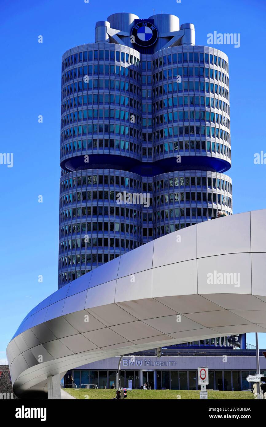 Striking tower with blue BMW symbol and futuristic architecture under a blue sky, BMW WELT, Munich, Germany Stock Photo