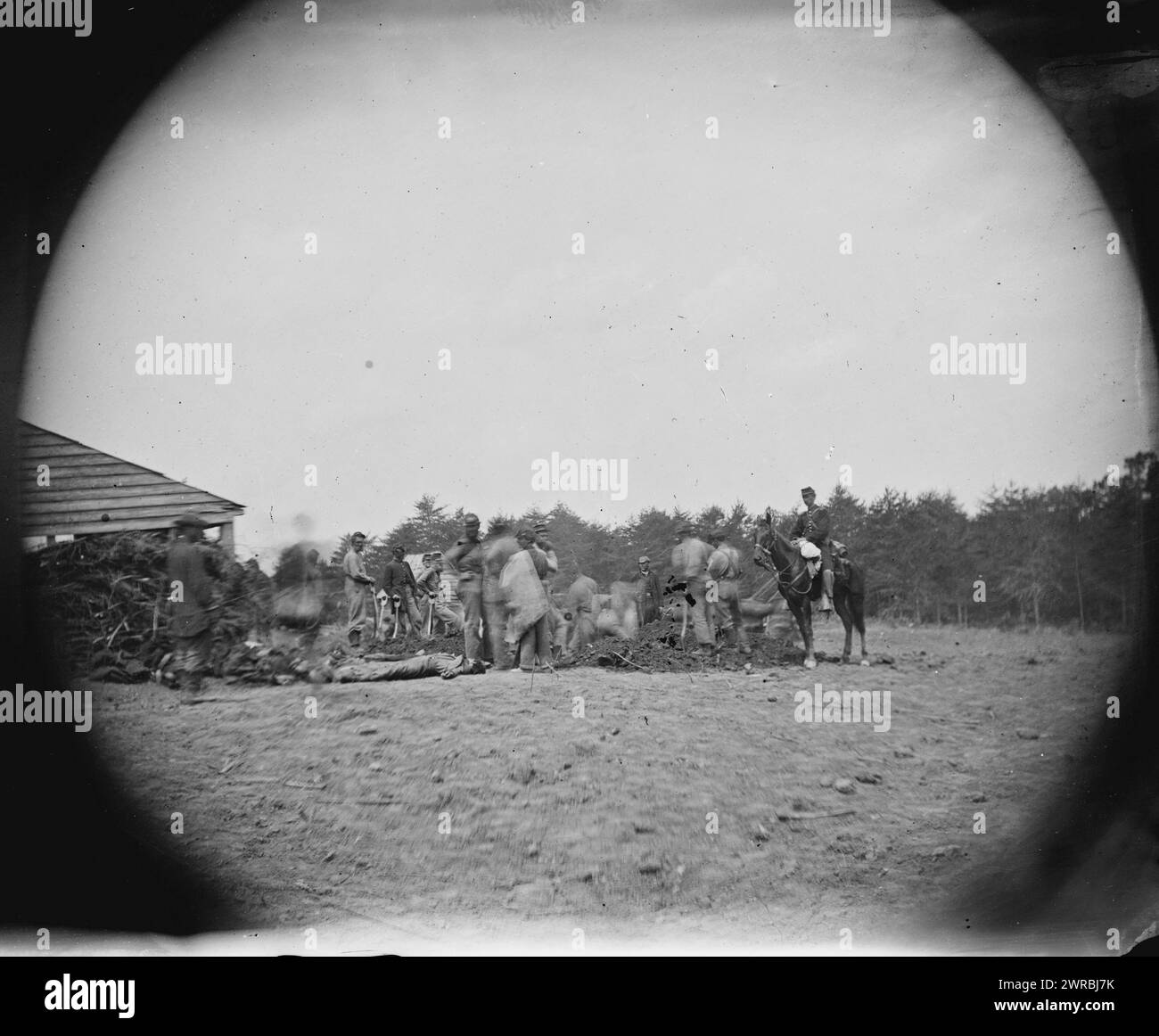 Spotsylvania Court House, Virginia (vicinity). 1st Mass. Heavy Artillery burying the dead at Mrs. Alsop's house after the battle of May 19th, O'Sullivan, Timothy H., 1840-1882, photographer, 1864 May 20, United States, History, Civil War, 1861-1865, Glass negatives, 1860-1870, Stereographs, 1860-1870, 1 negative: glass, stereograph, wet collodion, 4 x 10 in Stock Photo