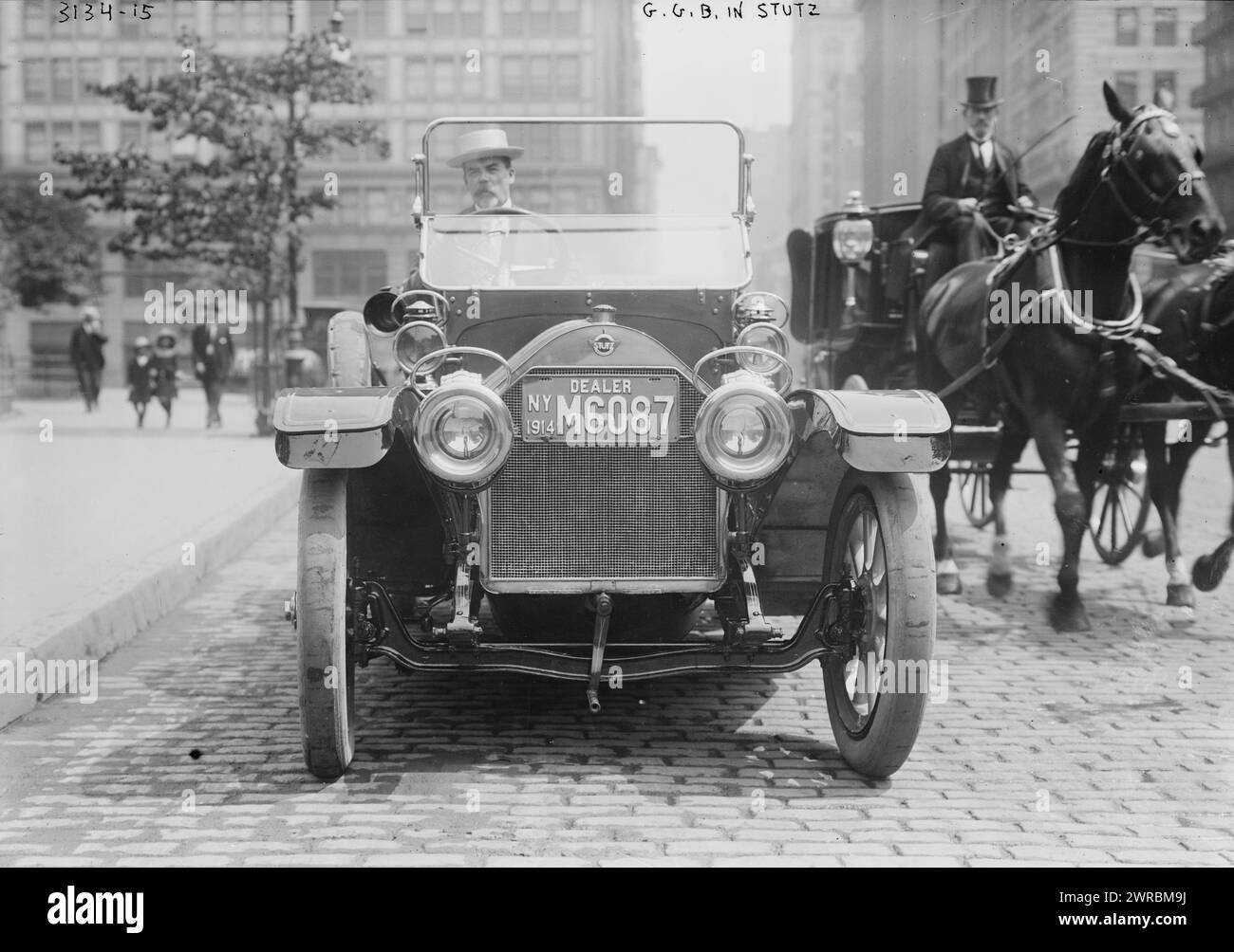 G.G.B. i.e., George Grantham Bain in Stutz, Photograph shows George Grantham Bain, head of the Bain News Service, driving a Stutz passenger car near Union Square, New York City. Reflection of the photographer is visible in the left headlight of the car., Includes photographer's reflection in the automobile headlight., 1914 July 4, Bain, George Grantham, 1865-1944, Glass negatives, 1 negative: glass Stock Photo