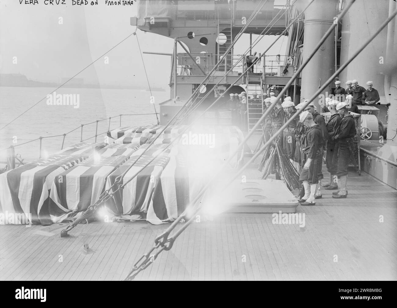 Vera Cruz dead on MONTANA, Photograph shows flag draped caskets on the Montana at Pier A, New York City before the National Memorial Service on May 11, 1914, in honor of the seamen and marines who were killed in Veracruz, Mexico during the Mexican Revolution., 1914 May 11, Glass negatives, 1 negative: glass Stock Photo