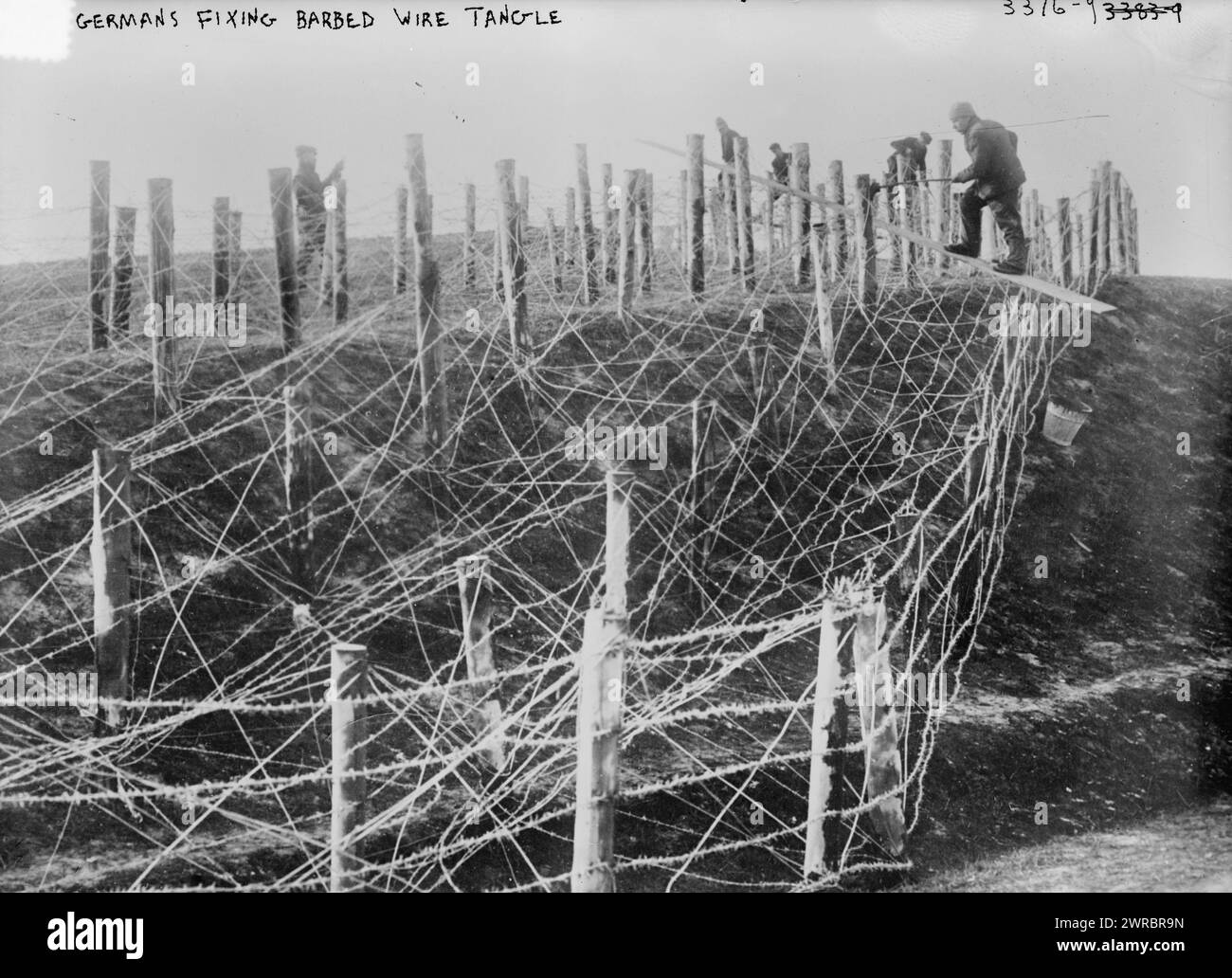 Germans fixing barbed wire tangle, Photograph shows German soldiers fixing a barbed wire entanglement during World War I., between ca. 1914 and ca. 1915, World War, 1914-1918, Glass negatives, 1 negative: glass Stock Photo