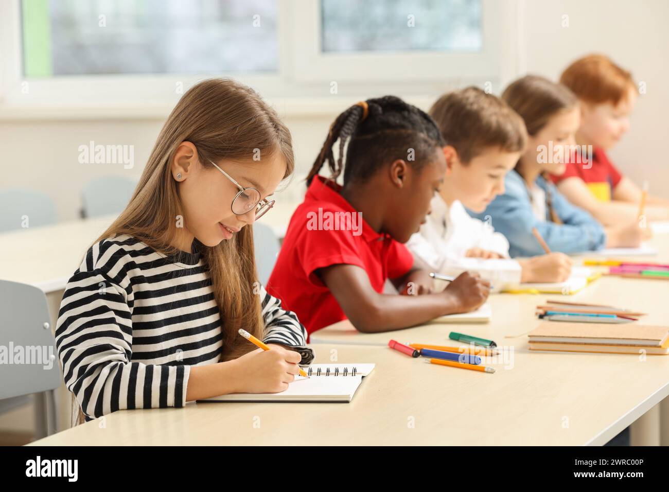 Cute children studying in classroom at school Stock Photo - Alamy