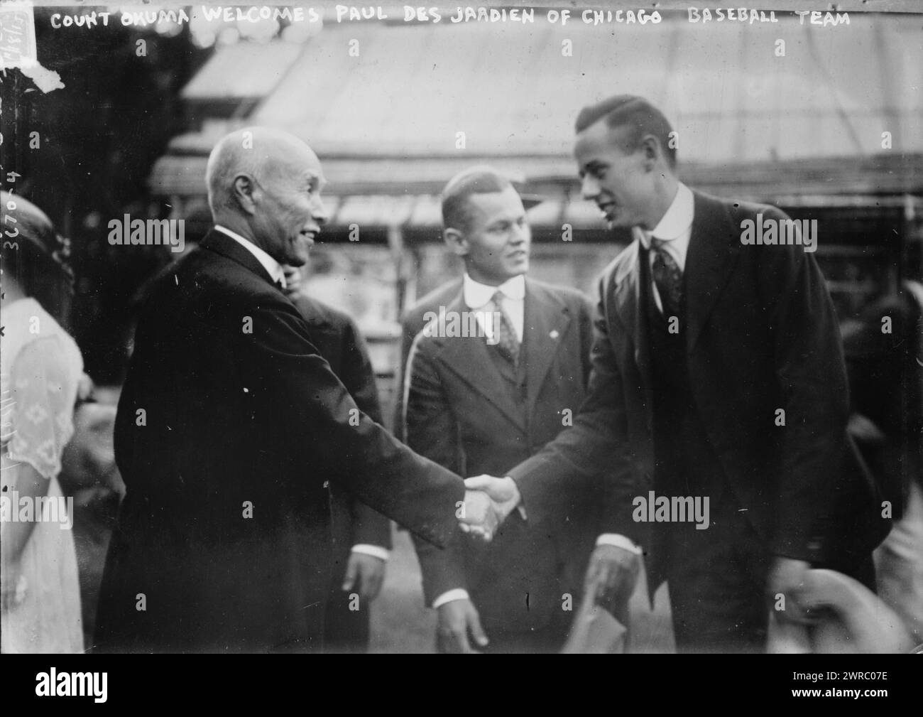 Count Okuma welcomes Paul Des Jardien of Chicago baseball team, 11/18/15, Photograph shows Marquess Okuma Shigenobu (1838-1922), Prime Minister of Japan, shaking hands with Paul Raymond 'Shorty' Des Jardien (1893-1956), an American football, baseball and basketball player who traveled with the University of Chicago to Japan in 1915., 1915 Nov. 18, Baseball, Glass negatives, 1 negative: glass Stock Photo