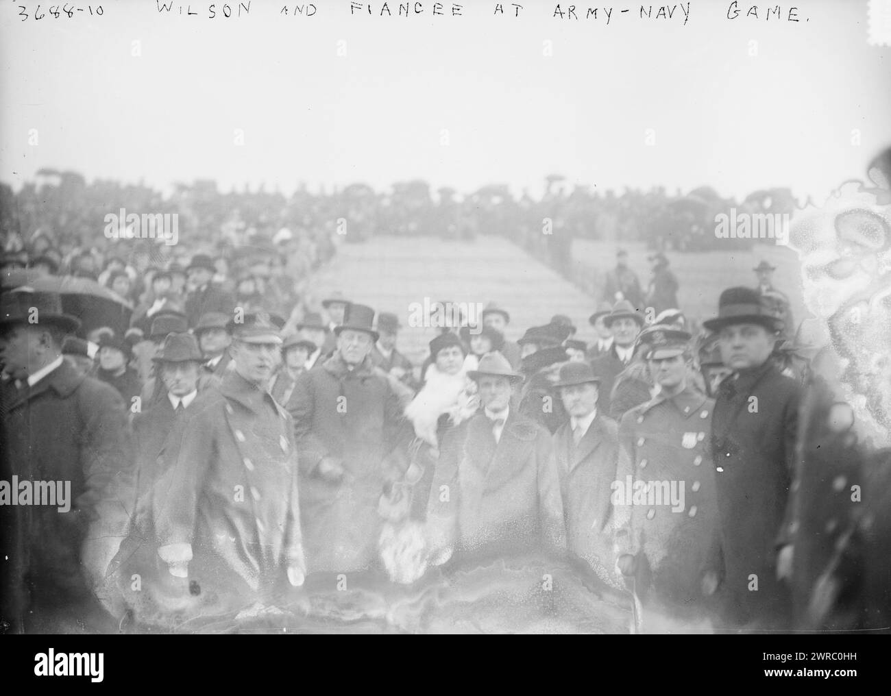 Wilson and fiancee at Army - Navy game, Photograph shows spectators including President Woodrow Wilson and his fiancee Edith Bolling Galt at the Army-Navy football game played at the Polo Grounds in New York City in 1915., 1915 Nov. 27, Glass negatives, 1 negative: glass Stock Photo