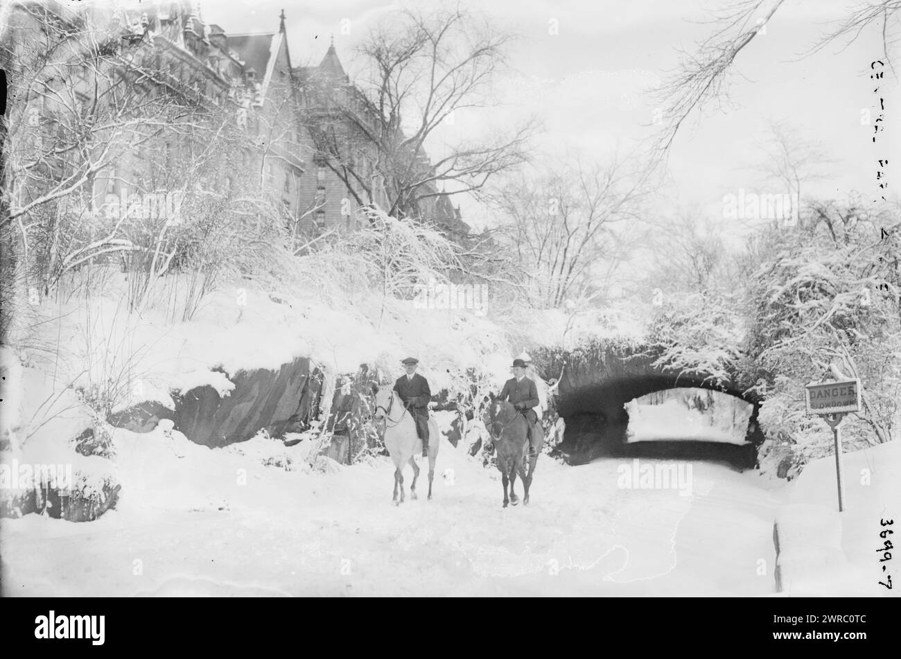 Central Park, Photograph shows men riding on horseback in Central Park, New York City, the Dakota apartment building in the background., between ca. 1910 and ca. 1915, Glass negatives, 1 negative: glass Stock Photo