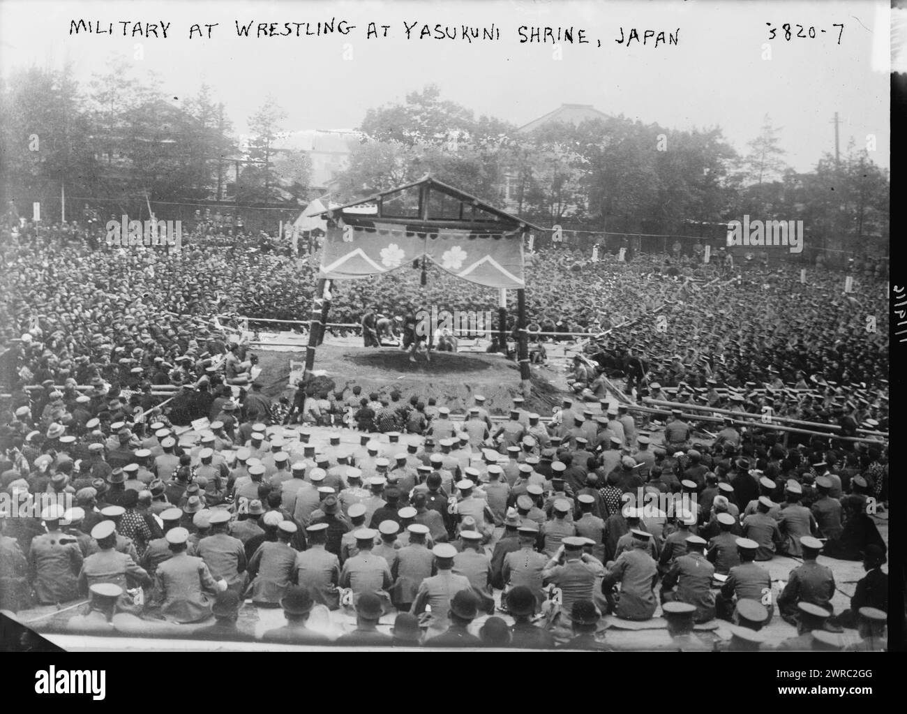 Military at Wrestling match at Yasukuni Shrine, Japan, Photograph shows a wrestling match at the Yasukuni Shrine, a Shinto shrine in Chiyoda, Tokyo, Japan which honors people who died serving Japan and is the site of annual sumo wrestling matches., 1916 April 19, Glass negatives, 1 negative: glass Stock Photo