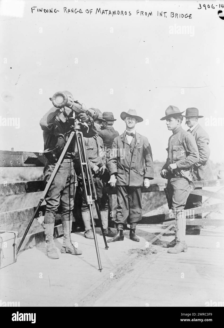 Finding Range of Matamoros from Int. Bridge, Photograph shows a survey crew from Fort Brown in Brownsville, Texas observing the Mexican city of Matamoros from the International Bridge., between ca. 1915 and ca. 1920, Glass negatives, 1 negative: glass Stock Photo