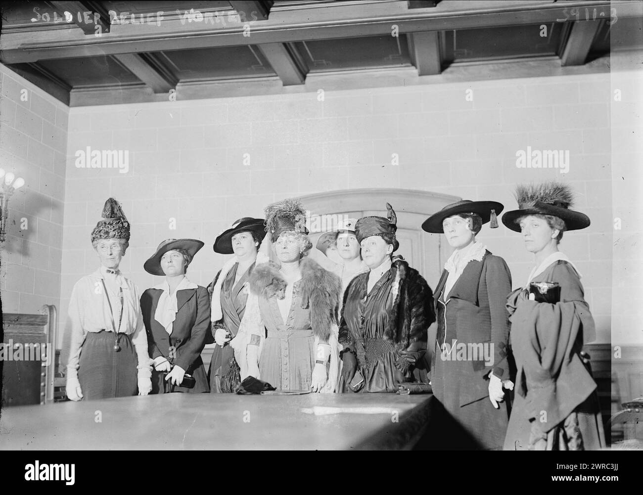 Soldier Relief Workers, Photograph shows members of the Active Service Auxiliary of the National Guard of New York, established in 1916 and organized by Mrs. Cornelius Vanderbilt (Grace Wilson Vanderbilt). Photographh includes Mrs. John F. (Janet Holmes) O'Ryan (1882-1958), Mrs. Edward Olmstead, Mrs. Fred M. Waterbury (Marty Blackmur Waterbury), Mrs. Oliver Bridgman, Mrs. Fred E. Humphries (Myrtle Lee Humphries). Women on either end are probably Mrs. William S. (Emilie Reinhart) Terriberry (1876-1948) and Mrs. William Whitehead Ladd., between ca. 1915 and ca. 1920, Glass negatives Stock Photo