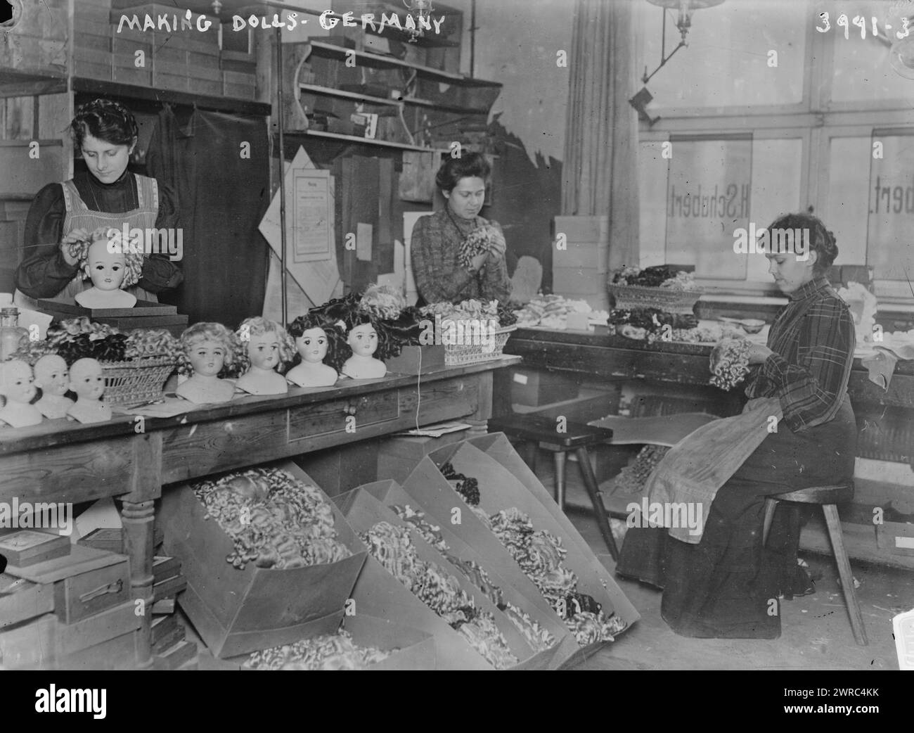 Making dolls, Germany, Photograph shows German toymakers whose work was impacted by the British blockage of German products in 1916., between ca. 1915 and 1916, Glass negatives, 1 negative: glass Stock Photo