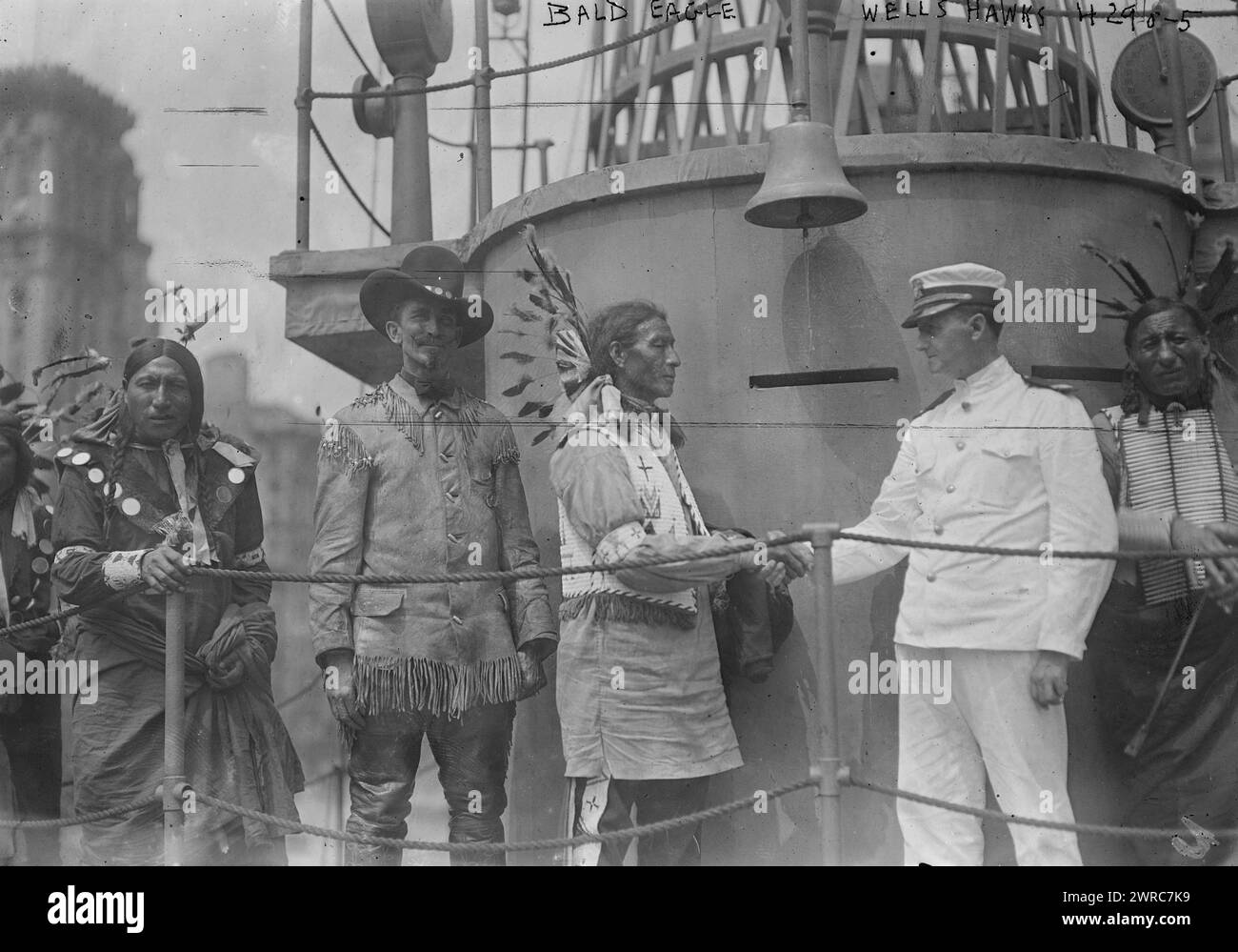 Bald Eagle, Wells Hawks, Photograph shows Native American 'chief Bald Eagle' shaking hands with Lt. Wells Hawks (1870-1941), a member of the Navy's public relations team aboard the USS Recruit. The ship was a wooden mockup of a battleship built in Union Square, New York City by the Navy to recruit seamen and sell Liberty Bonds during World War I., 1917 July 28, World War, 1914-1918, Glass negatives, 1 negative: glass Stock Photo