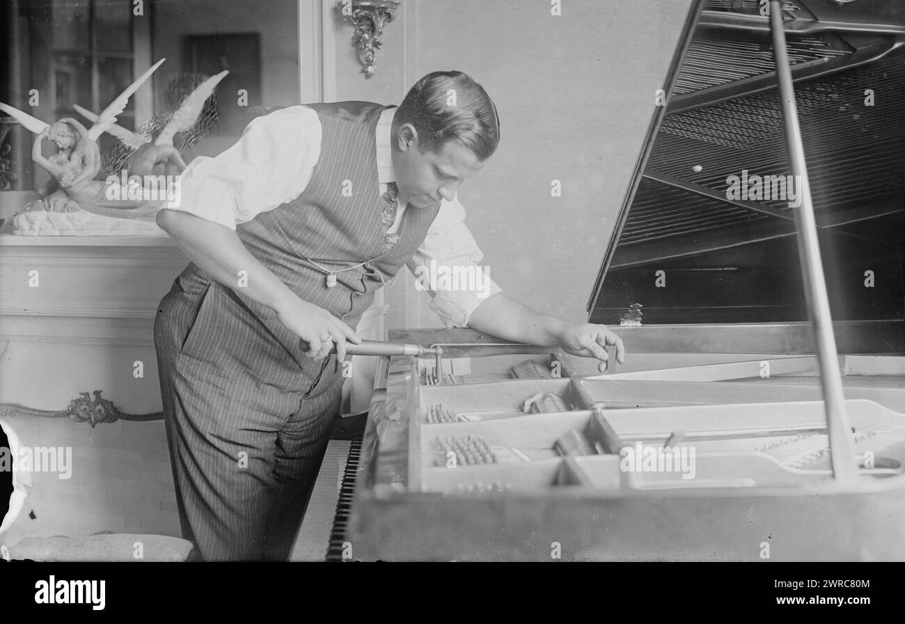 P. Althouse, Photograph shows Paul Shearer Althouse (1889-1954), an American opera singer tuning a piano., between ca. 1915 and ca. 1920, Glass negatives, 1 negative: glass Stock Photo