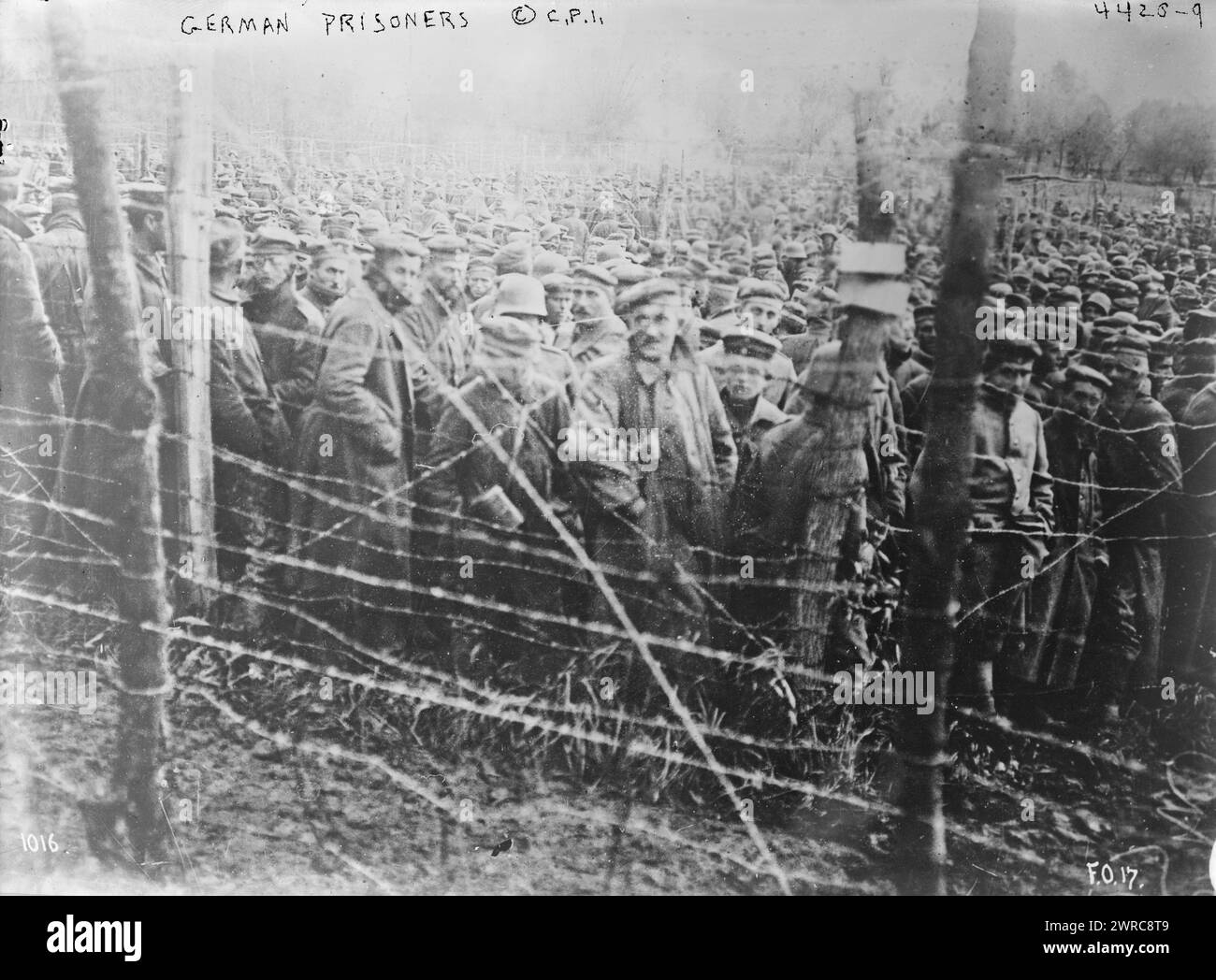 German prisoners, Photograph shows German prisoners of war behind barbed wire fence during World War I., between ca. 1915 and 1918, World War, 1914-1918, Glass negatives, 1 negative: glass Stock Photo