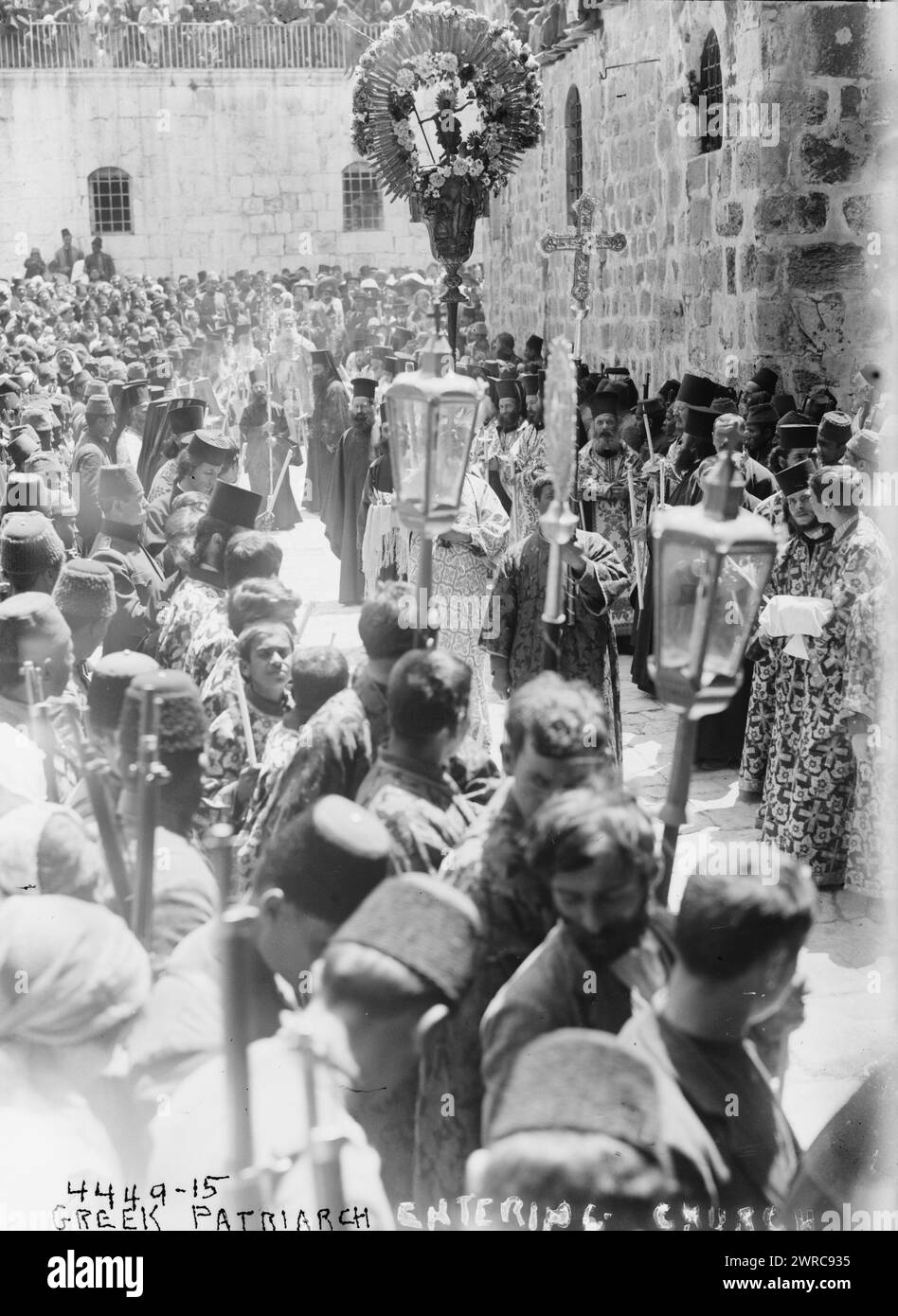 Greek patriarch entering church, Photograph shows a religious procession with the Greek Orthodox Patriarch of Jerusalem going into the Church of the Holy Sepulchre. People in procession hold cross and a monstrance., between ca. 1915 and ca. 1920, Glass negatives, 1 negative: glass Stock Photo
