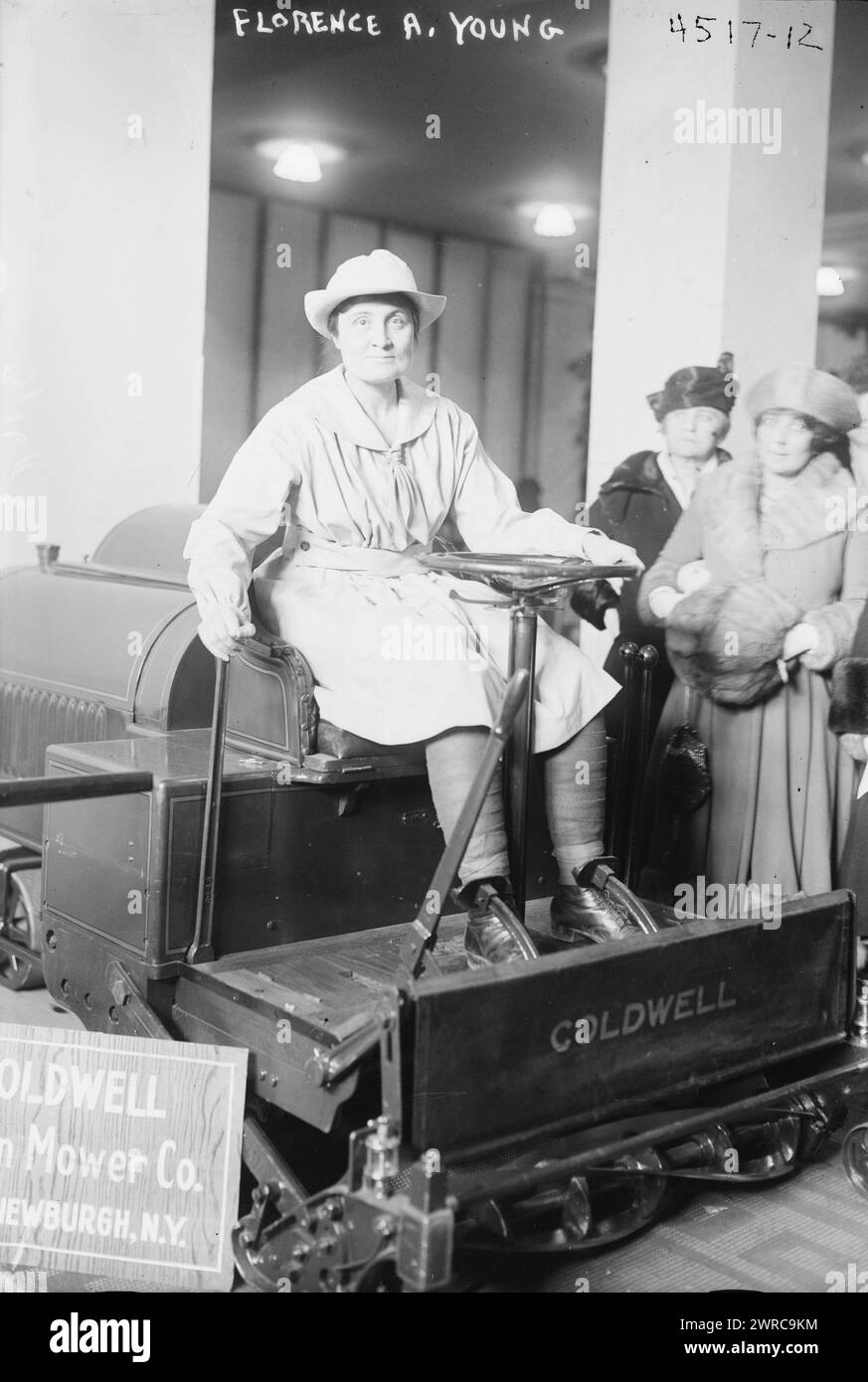 Florence A. Young, Photograph shows Florence A. Young who organized a motorcycle corps to train women for emergency riding during World War I, seated on a Coldwell mower, possibly during the International Flower Show at the Grand Central Palace, New York City, March 1918., 1918 March, Glass negatives, 1 negative: glass Stock Photo