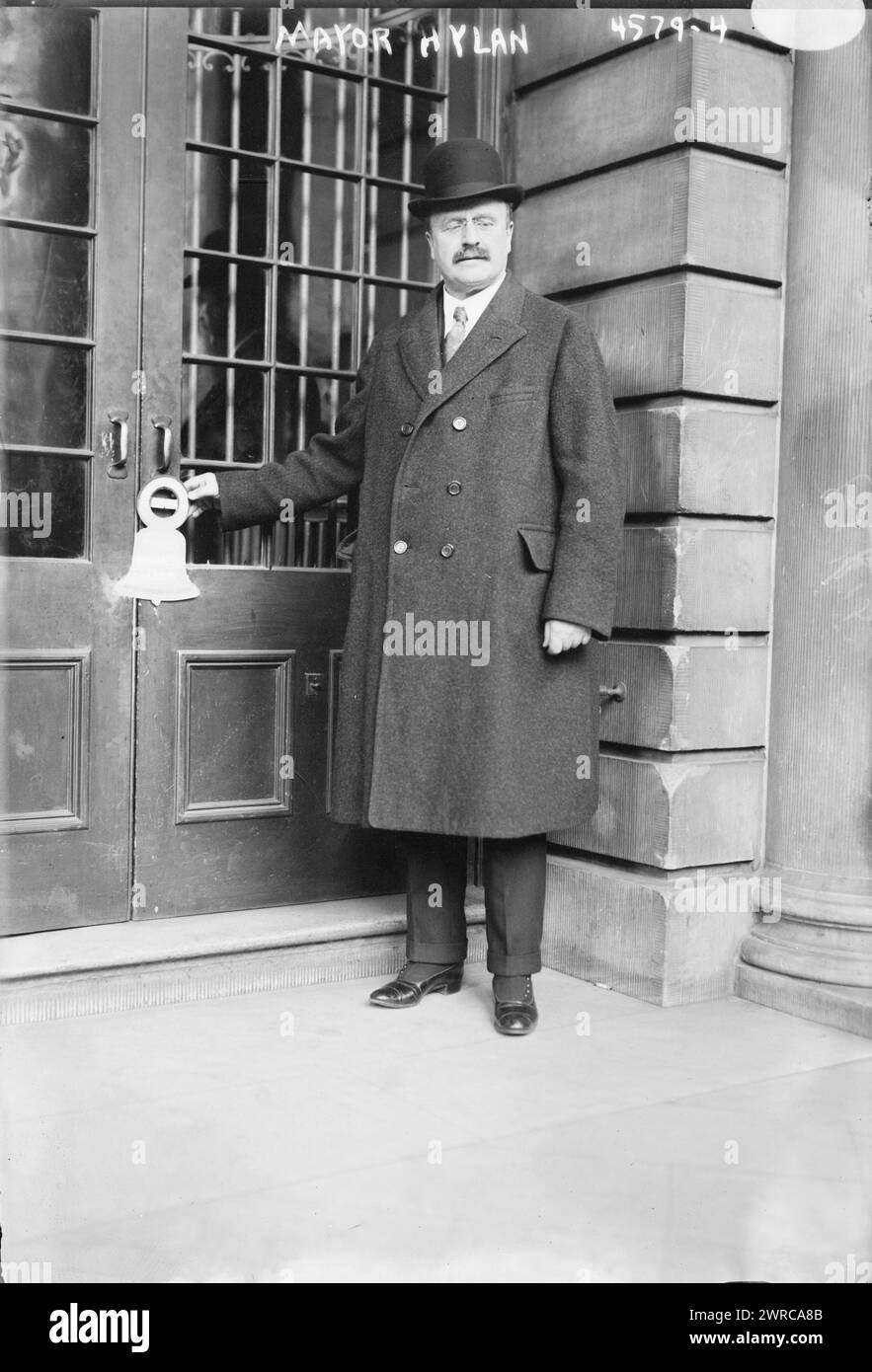Mayor Hylan, Photograph shows New York City's Mayor John Francis Hylan (1868-1936) with advertisement for government bonds from Third Liberty Loan as a Liberty bell-shaped cut-out hanging from a doorknob., between ca. 1915 and ca. 1920, World War, 1914-1918, Glass negatives, 1 negative: glass Stock Photo