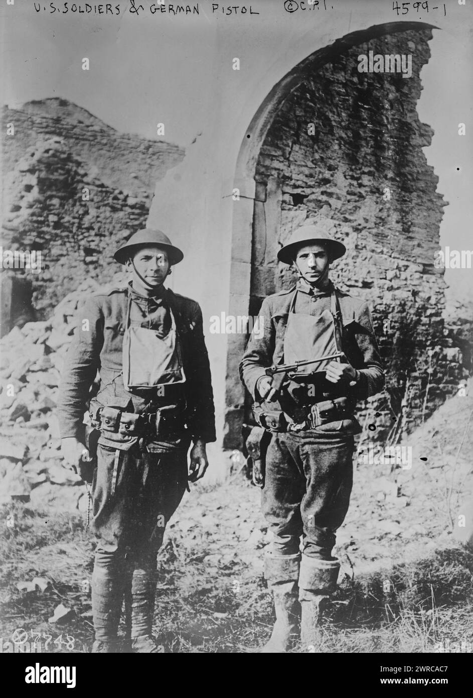 U.S. soldiers & German pistol, Photograph shows two American soldiers, Corporal Howard Thompson and James H. White who were part of a group that killed and captured several Germans in no man's land on March 7, 1918 during World War I. Thompson holds a pistol taken from a German soldier killed by White. Photograph was taken in Ancerviller, France, March 11, 1918., 1918 March 11, World War, 1914-1918, Glass negatives, 1 negative: glass Stock Photo
