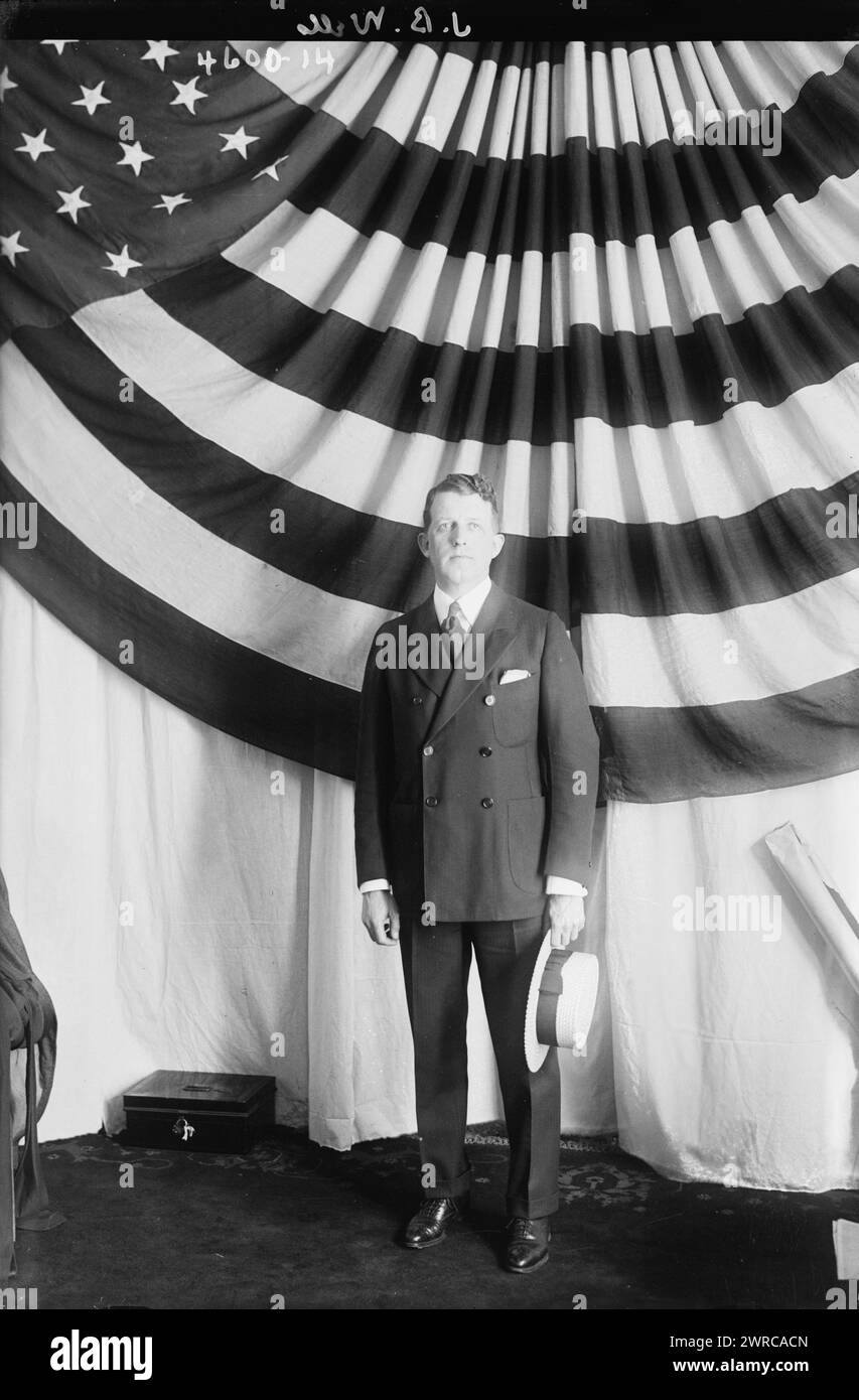 J.B. Wells, Photograph shows tenor singer John Barnes Wells (October 17, 1880 - August 8, 1935) standing in front of an American flag., 1917 and 1918, Glass negatives, 1 negative: glass Stock Photo